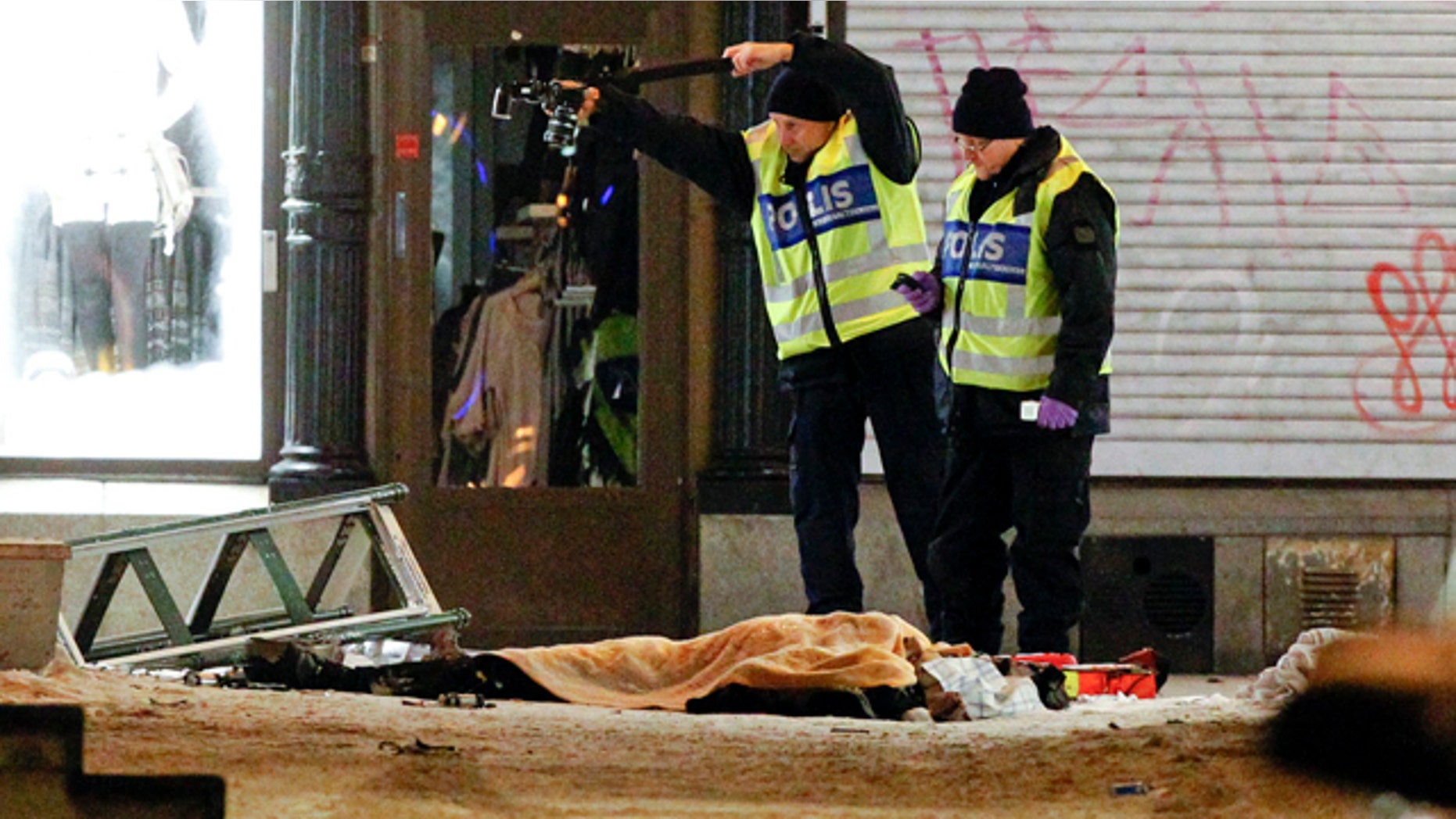 Police forensics experts examine the scene in Stockholm after an apparent suicide attack