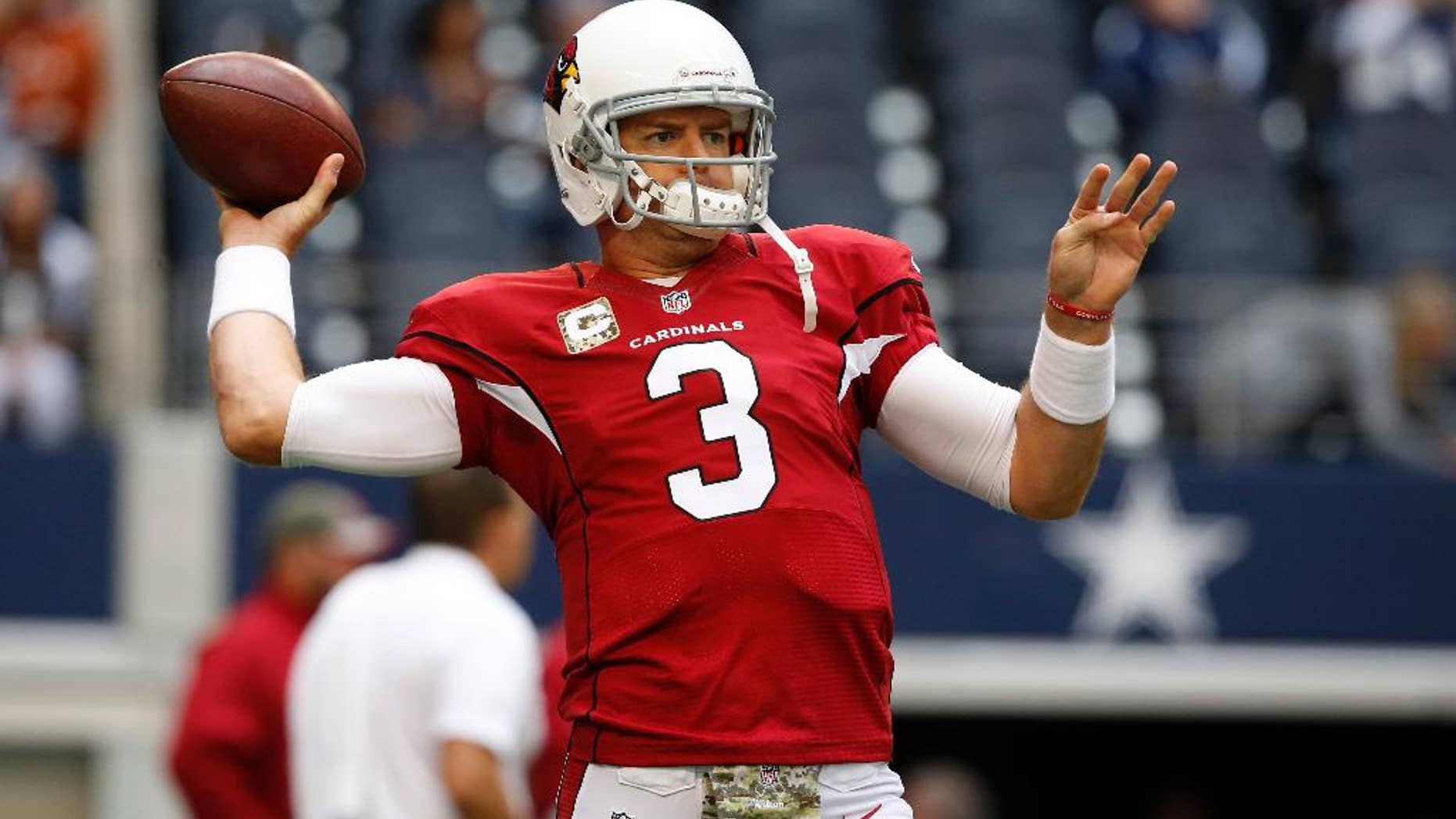 Arizona Cardinals quarterback Carson Palmer (3) warms up before an NFL football game against the Dallas Cowboys Sunday, Nov. 2, 2014, in Arlington, Texas. (AP Photo/Sue Ogrocki)