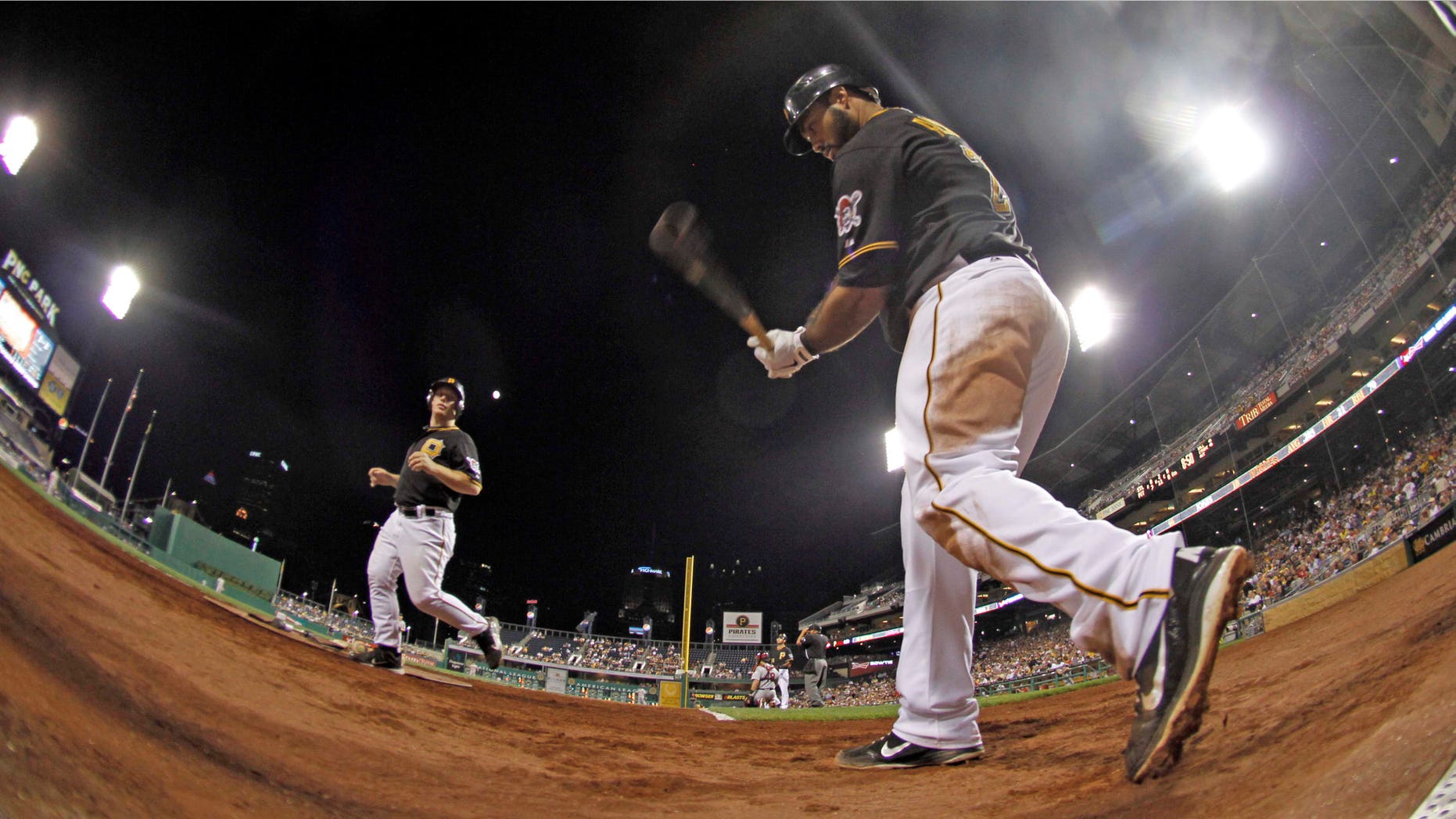In this photo made with a fisheye lens, Pittsburgh Pirates' Pedro Alvarez, right, warms up on deck before batting in the sixth inning of the baseball game against the St. Louis Cardinals on Tuesday, Aug. 28, 2012, in Pittsburgh. Alvarez hit his second homer of the night in the subsequent at bat as the Pirates won 9-0. (AP Photo/Keith Srakocic)