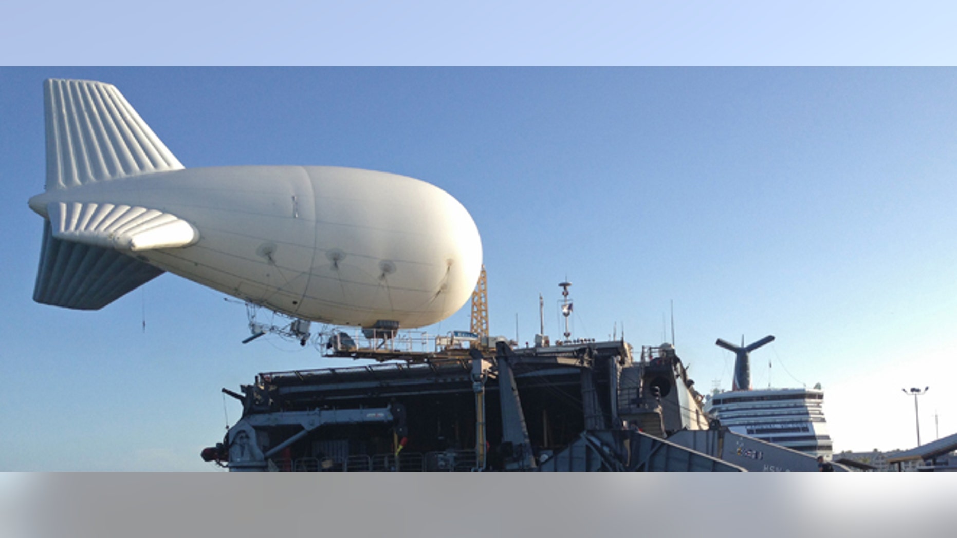 A balloon-like craft known as an aerostat is shown attached to the back of the U.S. Navy high speed vessel Swift docked in Key West, Florida, Friday, April 26, 2013. The U.S. Navy on Friday began testing two new aerial tools, borrowed from the battlefields of Afghanistan and Iraq, that officials say will make it easier to detect, track and videotape drug smugglers in action. (AP Photo/Ben Fox)