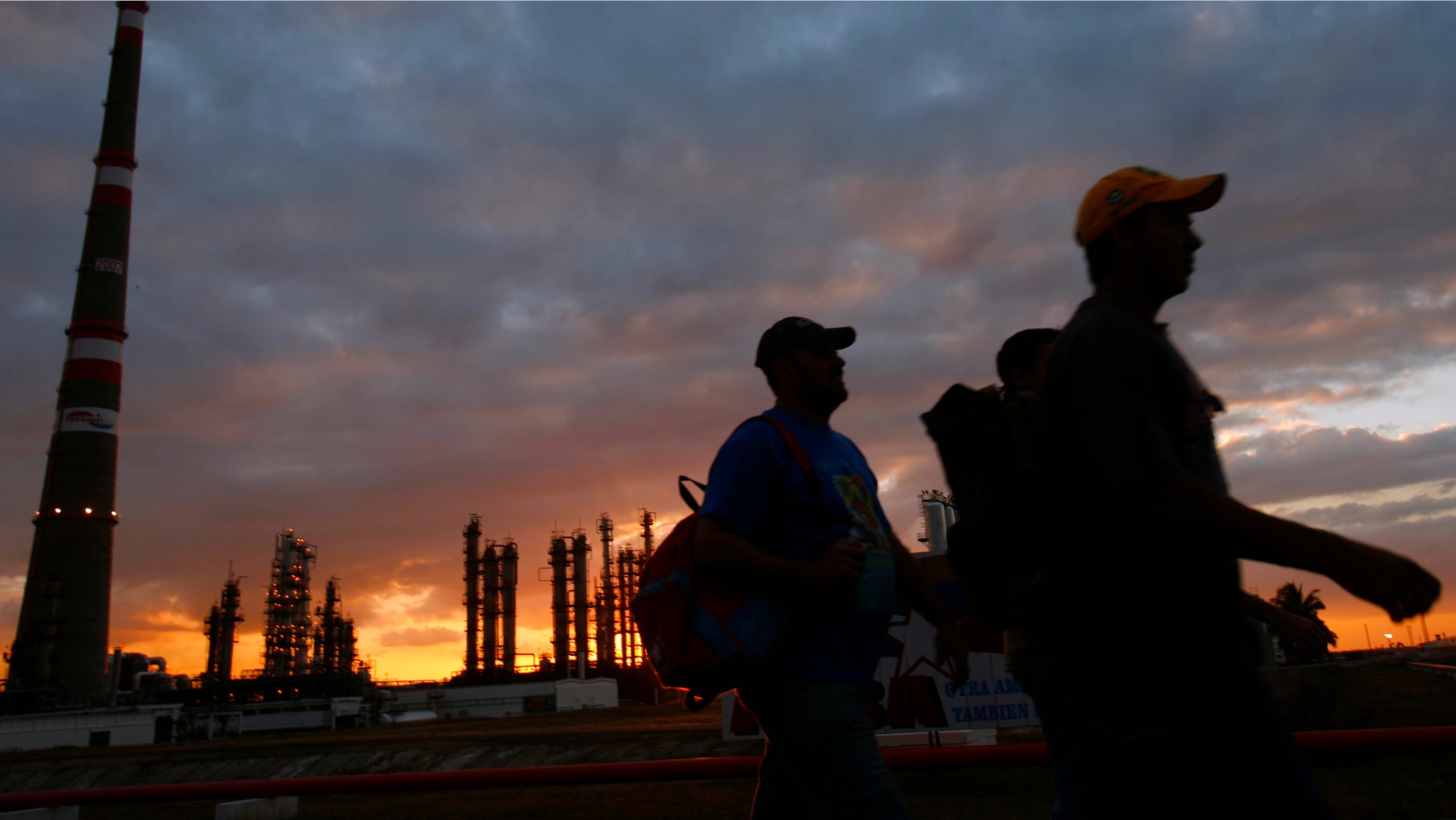 FILE - In this Dec. 20, 2007 file photo, workers leave their shift as Cubans prepare to inaugurate the Camilo Cienfuegos refinery ahead the IV Petrocaribe Summit in Cienfuegos, Cuba. Fears that falling oil prices could knock the wheels off the already wobbly economy of oil-dependent Venezuela have sparked apparent interest in alternatives to Petrocaribe, a trade program created by the late President Hugo Chavez that has kept the region dependent on the South American country for energy. All the countries of the region, except Cuba, are expected to participate in closed talks that will involve U.S. Vice President Joe Biden and other U.S. officials as well as representatives of the European Union, the U.N., and multi-lateral financing agencies such as the World Bank and Inter-American Development Bank. (AP Photo/Dado Galdieri, File)