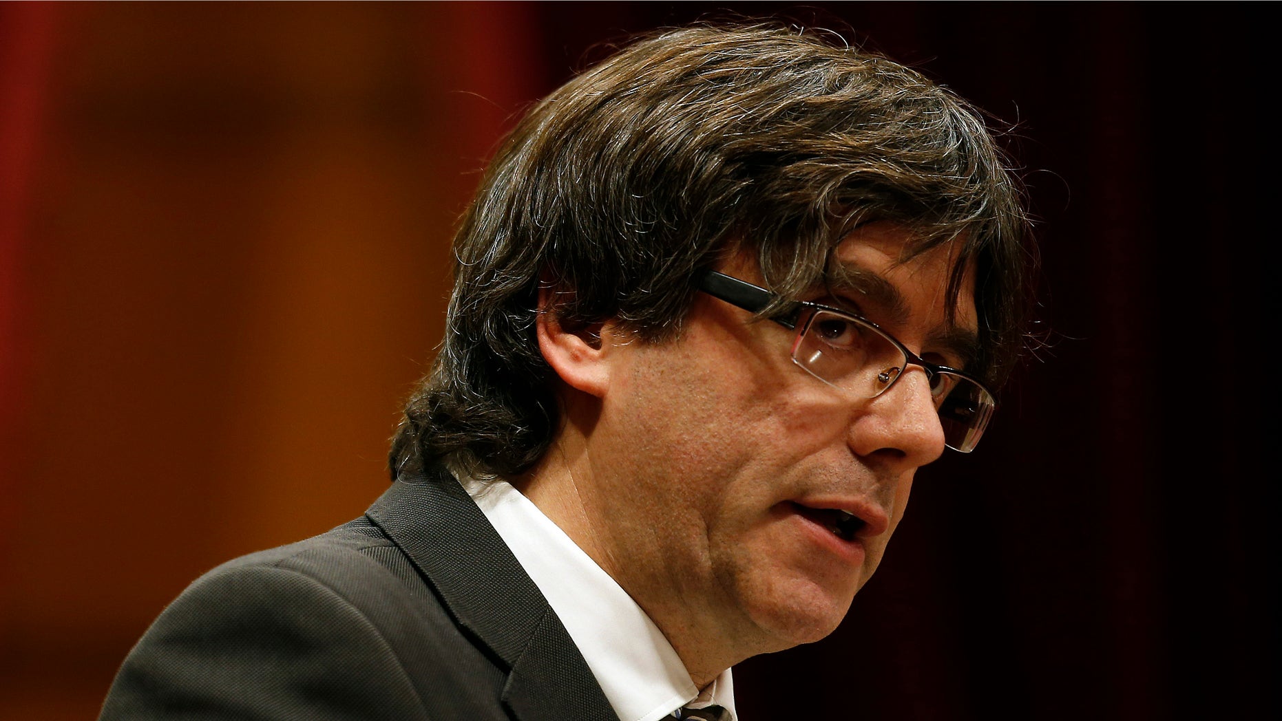 Incoming Catalan President Carles Puigdemont speaks during the investiture session at the Catalonian parliament in Barcelona, Spain, Sunday, Jan. 10, 2016. Catalonia's pro-independence parties have agreed to appoint a new leader to enable the creation of a regional coalition government and reinvigorate a push for independence from Spain by 2017. Carles Puigdemont was selected Saturday to replace Artur Mas as the "Together for Yes" alliance's candidate for regional government leader. (AP Photo/Manu Fernandez)