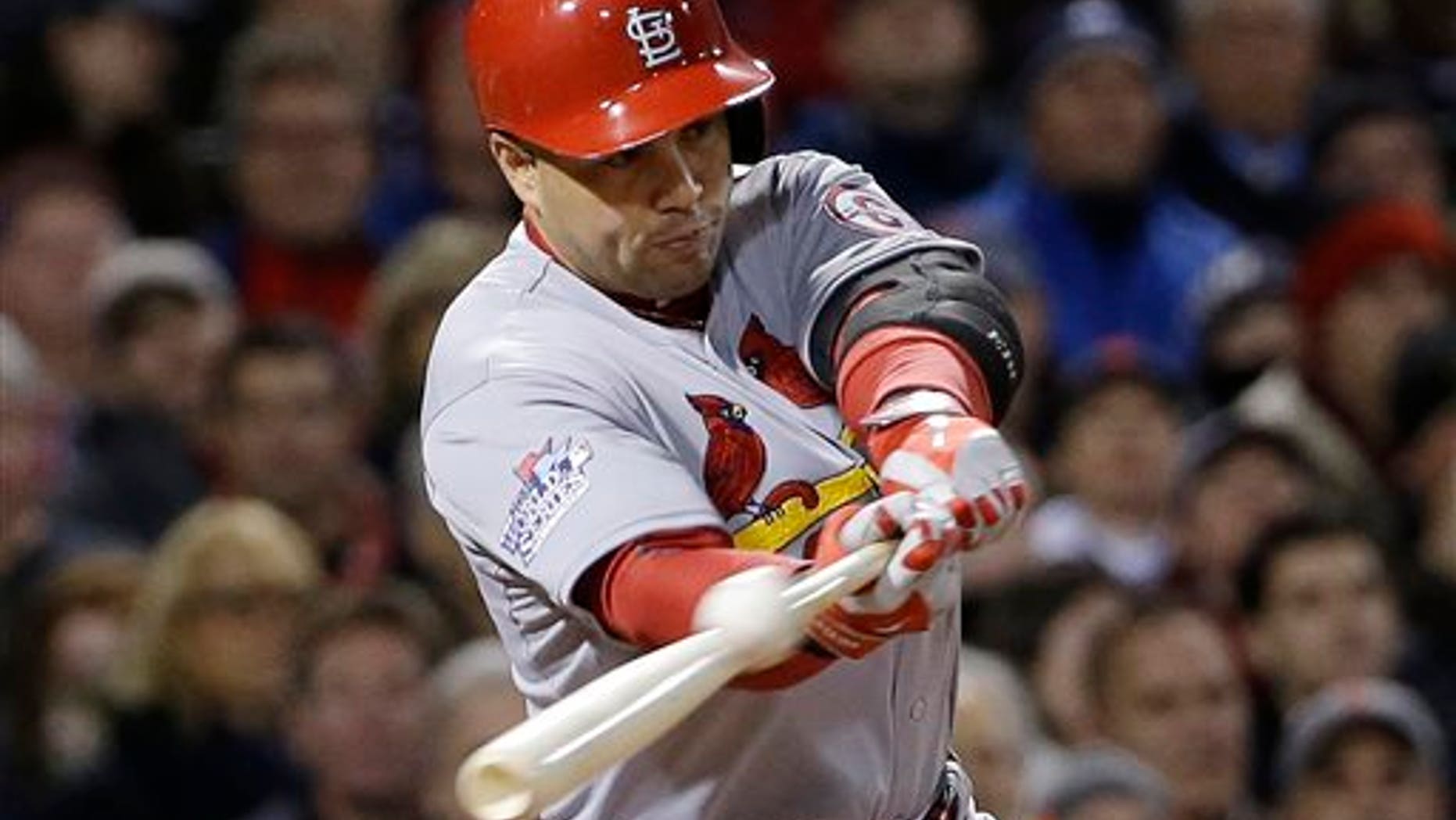 FILE - In this Oct. 24, 2013, file photo, St. Louis Cardinals' Carlos Beltran hits an RBI single during Game 2 of baseball's World Series against the Boston Red Sox in Boston. Two people familiar with the negotiations say outfielder Carlos Beltran and the New York Yankees have agreed to a $45 million, three-year contract. (AP Photo/David J. Phillip, File)