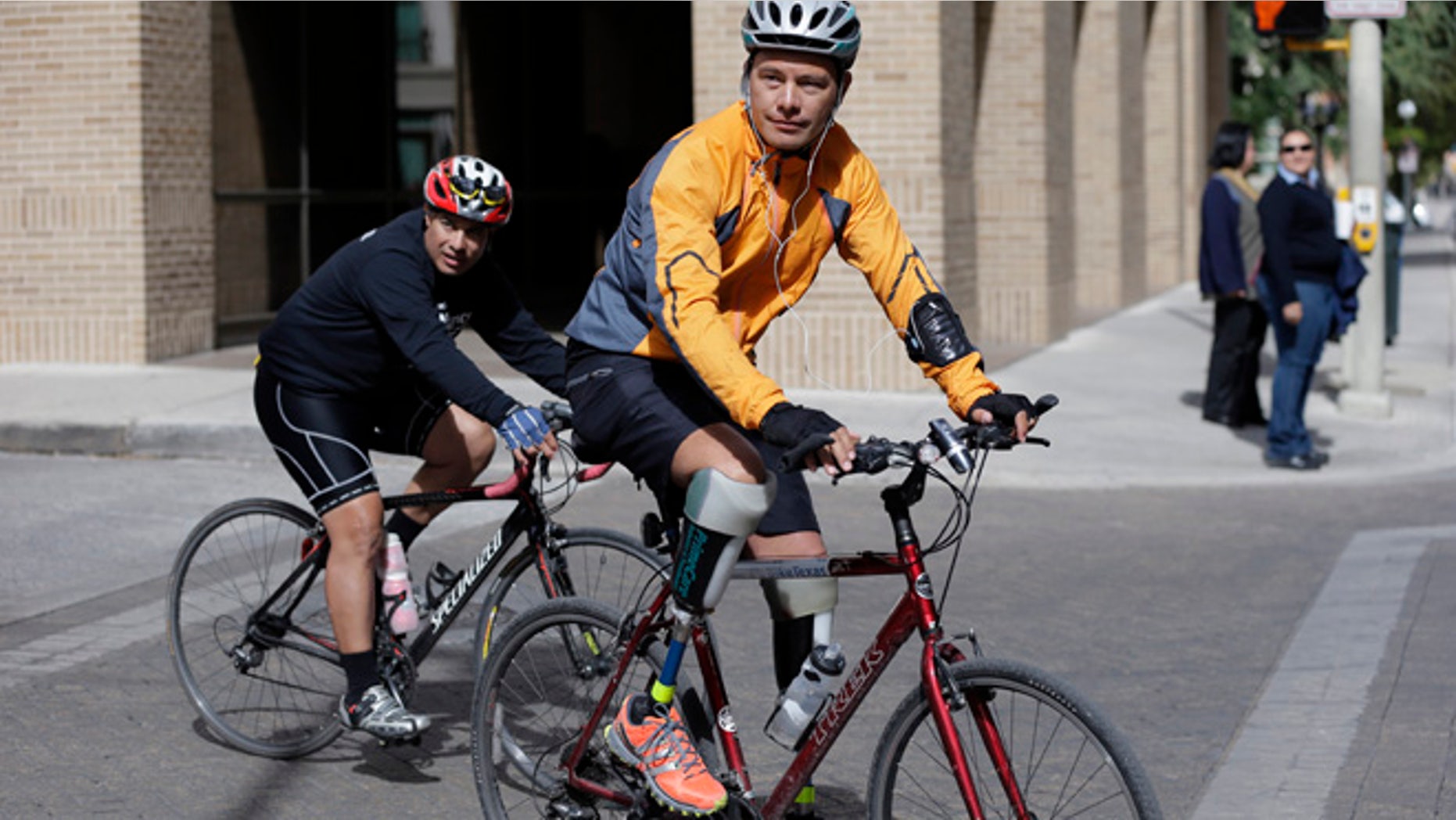Nov. 7, 2013: Cyclist Carlos Gutierrez, right, a double amputee, rides his bike in San Antonio. Gutierrez, a Mexican asylum seeker who fled to the U.S. after extortionists cut his legs off for not paying the extortion fees, has ridden his bike from El Paso, Texas to Austin, Texas, to raise awareness on the situation of political asylum seekers.