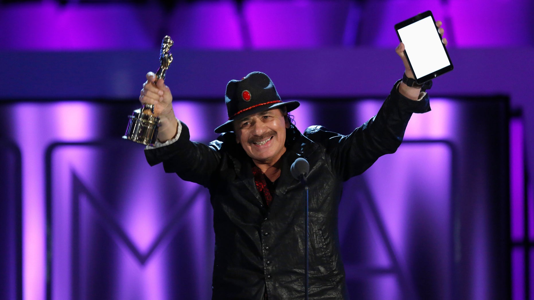 Musician Carlos Santana accepts the Outstanding Commitment to Cause and Community Award at the 2013 NCLR ALMA Awards at the Pasadena Civic Auditorium in Pasadena, California September 27, 2013.