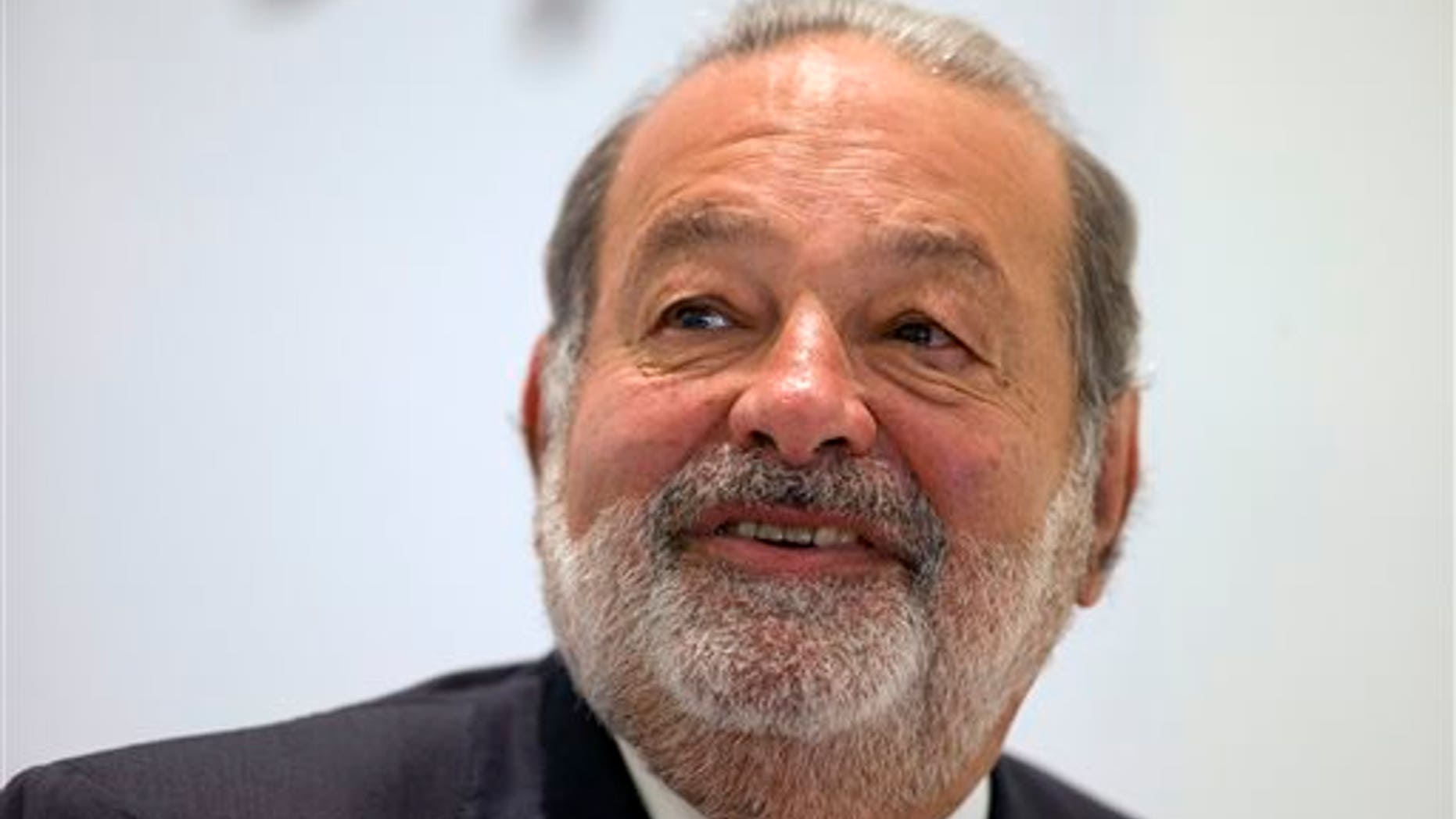 FILE - In this Jan. 14, 2013 file photo, Mexican telecommunications tycoon Carlos Slim speaks during news conference at the Soumaya museum in Mexico City. Slim is scheduled to give the closing speech on Sunday, Aug. 17, 2014, at the annual conference of the Catholic Association of Latino Leaders. (AP Photo/Dario Lopez-Mills, File)