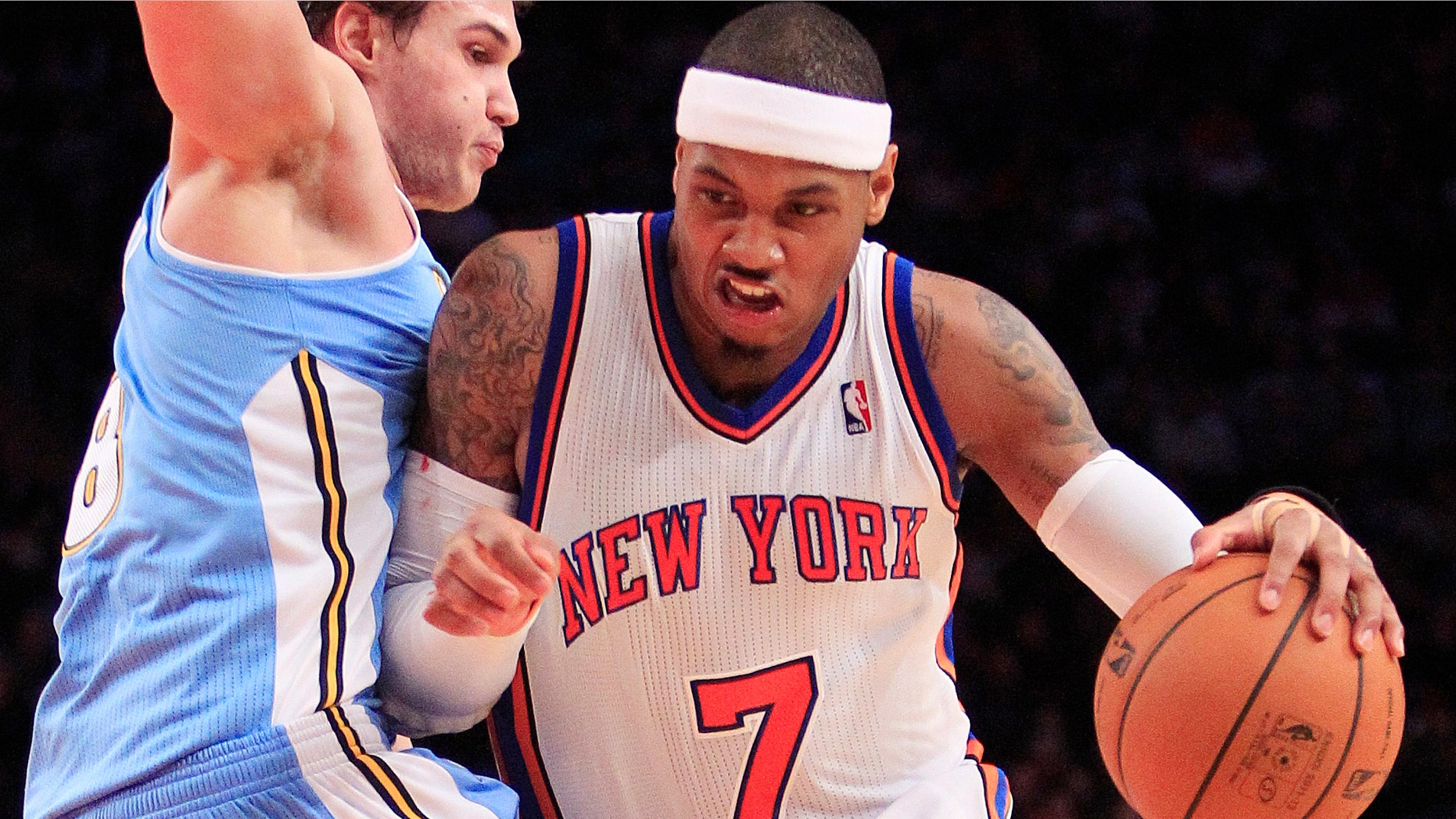 New York Knicks' Carmelo Anthony drives past Denver Nuggets' Danilo Gallinari, of Italy, during the first half of an NBA basketball game Saturday, Jan. 21, 2012, in New York. (AP Photo/Frank Franklin II)