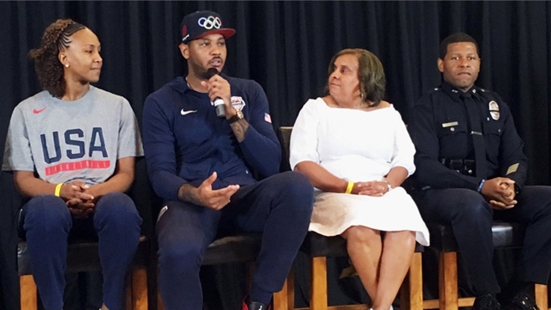 Carmelo Anthony with Tamika Catchings, left, Charisse Bremond Weaver and LAPD Deputy Chief Bill Scott.