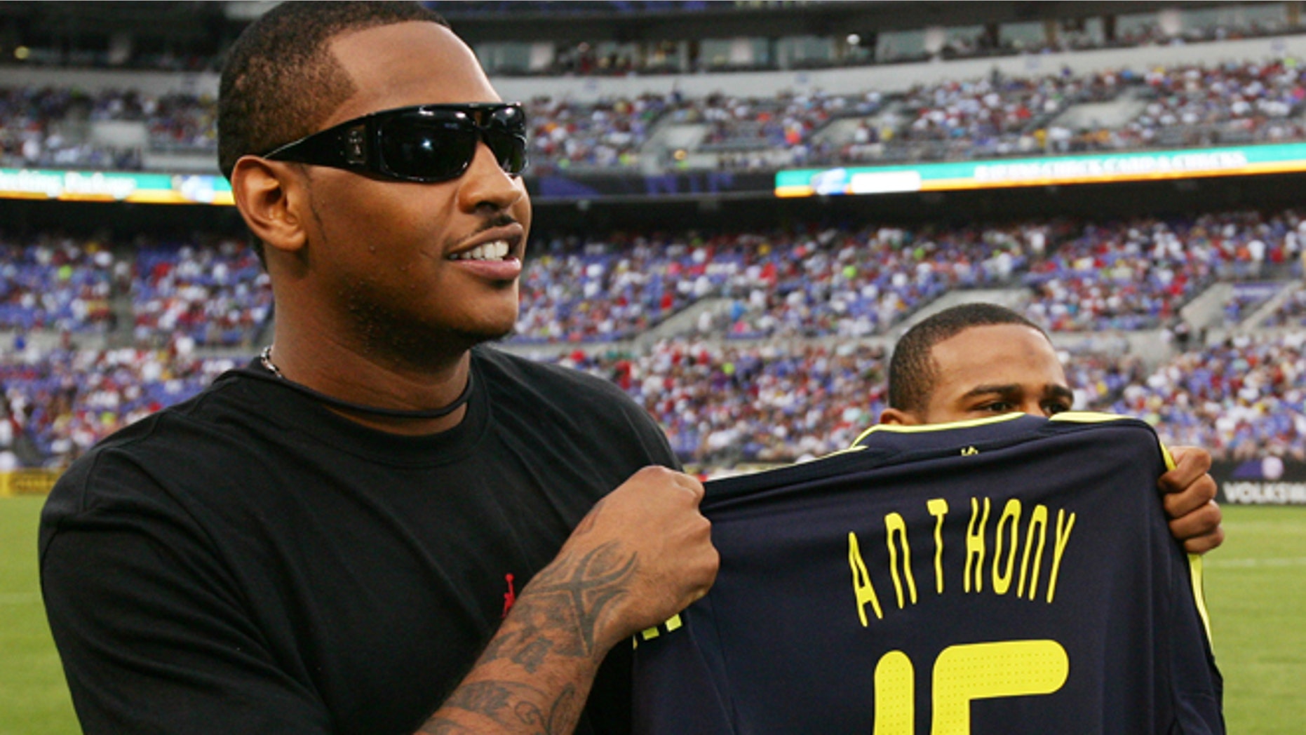 BALTIMORE - JULY 24: NBA player Carmelo Anthony holds up a personalized Chelsea FC jersey before the game between AC Milan and Chelsea FC at M & T Bank Stadium on July 24, 2009 in Baltimore, Maryland. (Photo by Ned Dishman/Getty Images) *** Local Caption *** Carmelo Anthony