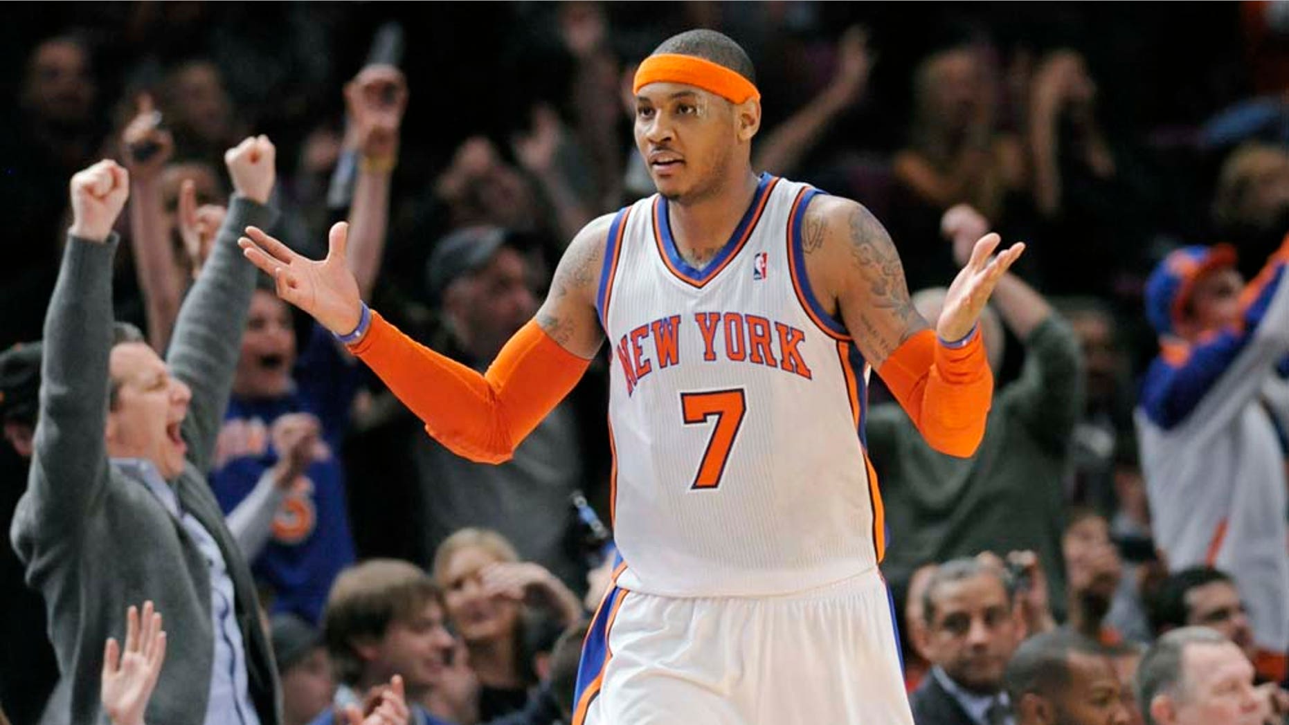 New York Knicks' Carmelo Anthony reacts as the fans cheer after he hit a shot during the fourth quarter of an NBA basketball game against the Orlando Magic Monday, March 28, 2011 at Madison Square Garden in New York. Anthony led all scorers with 39 points as the Knicks won 113-106 in overtime. (AP Photo/Bill Kostroun)
