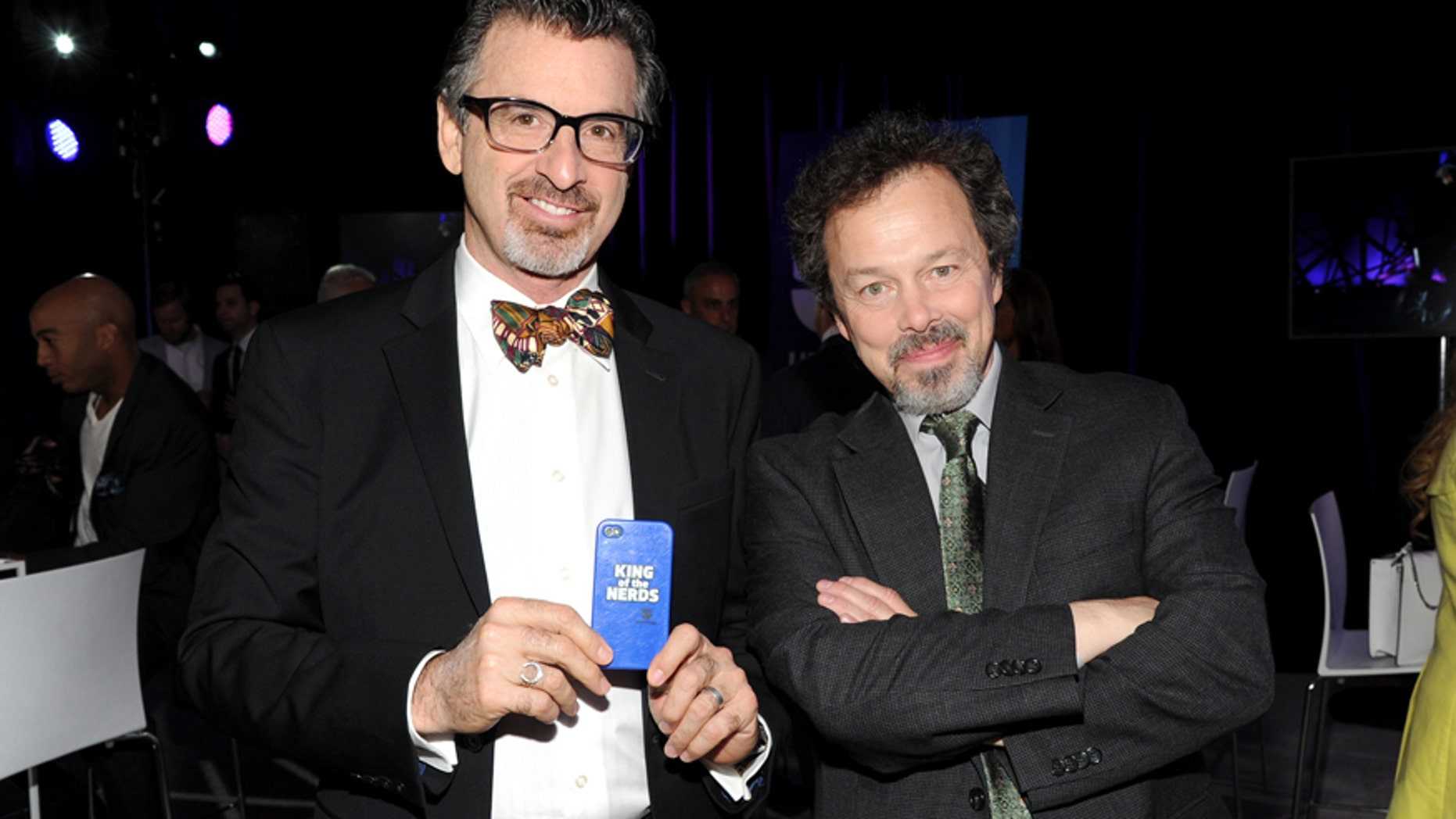 FILE - In this May 15, 2013 file photo, "King of the Nerds" co-hosts Robert Carradine, left, and Curtis Armstrong attend the TNT and TBS 2013 Upfront at the Hammerstein Ballroom, in New York.