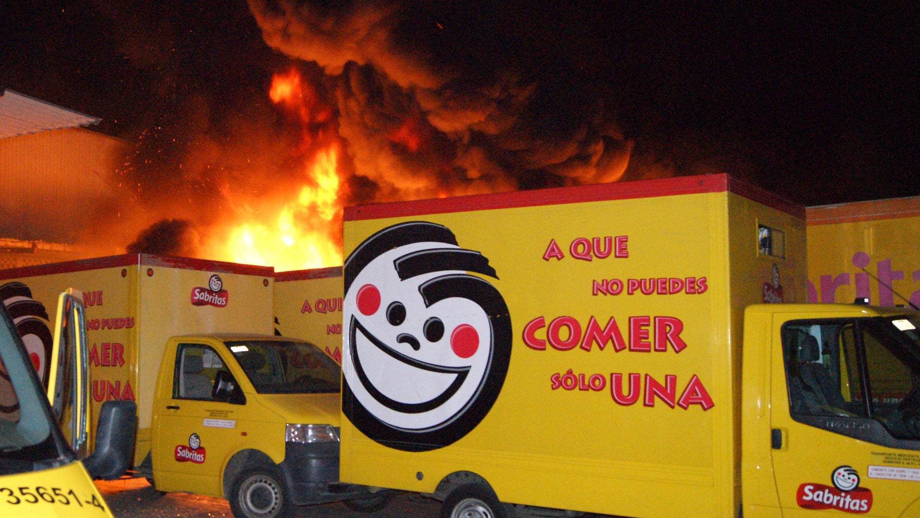 Friday, May 25, 2012. Flames rise from a warehouse of the Mexican potato-chip company Sabritas, in Lazaro Cardenas, Mexico. Sabritas is a subsidiary of PepsiCo. (AP Photo)
