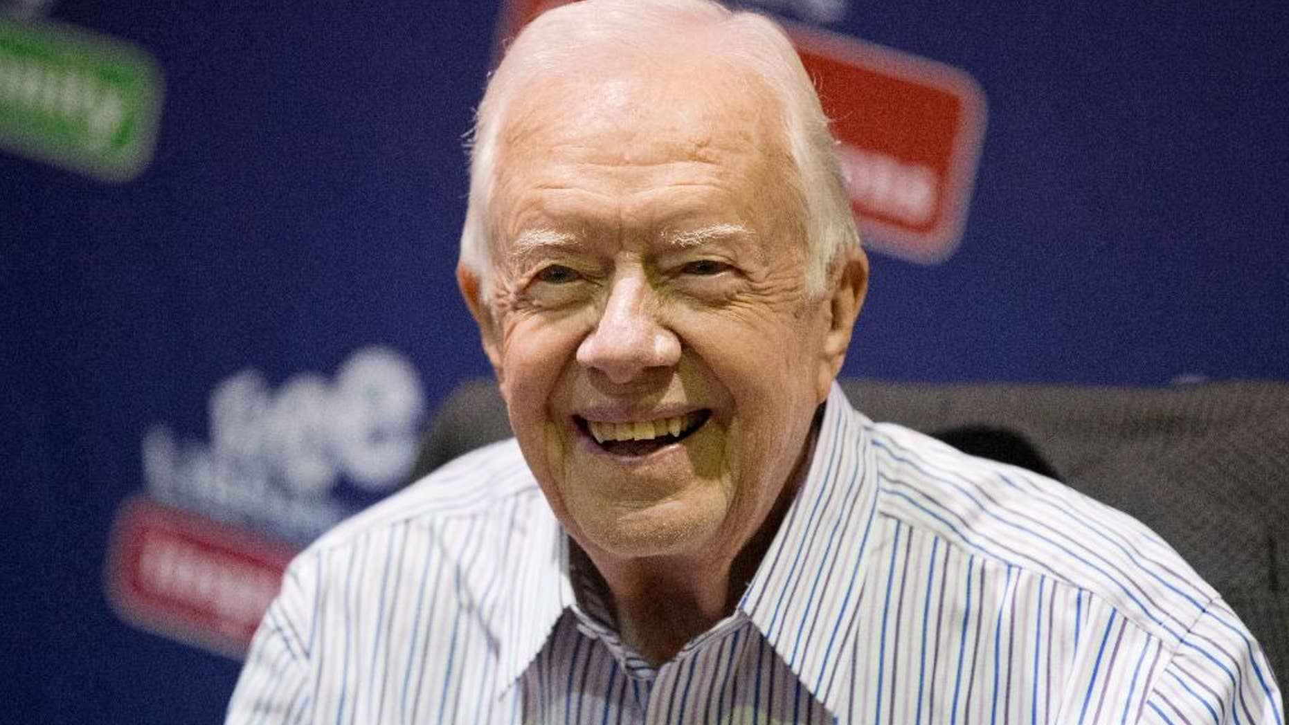 FILE - In this July 10, 2015, file photo, former President Jimmy Carter poses for photographs at an event for his new book "A Full Life: Reflections at Ninety at the Free Library in Philadelphia.