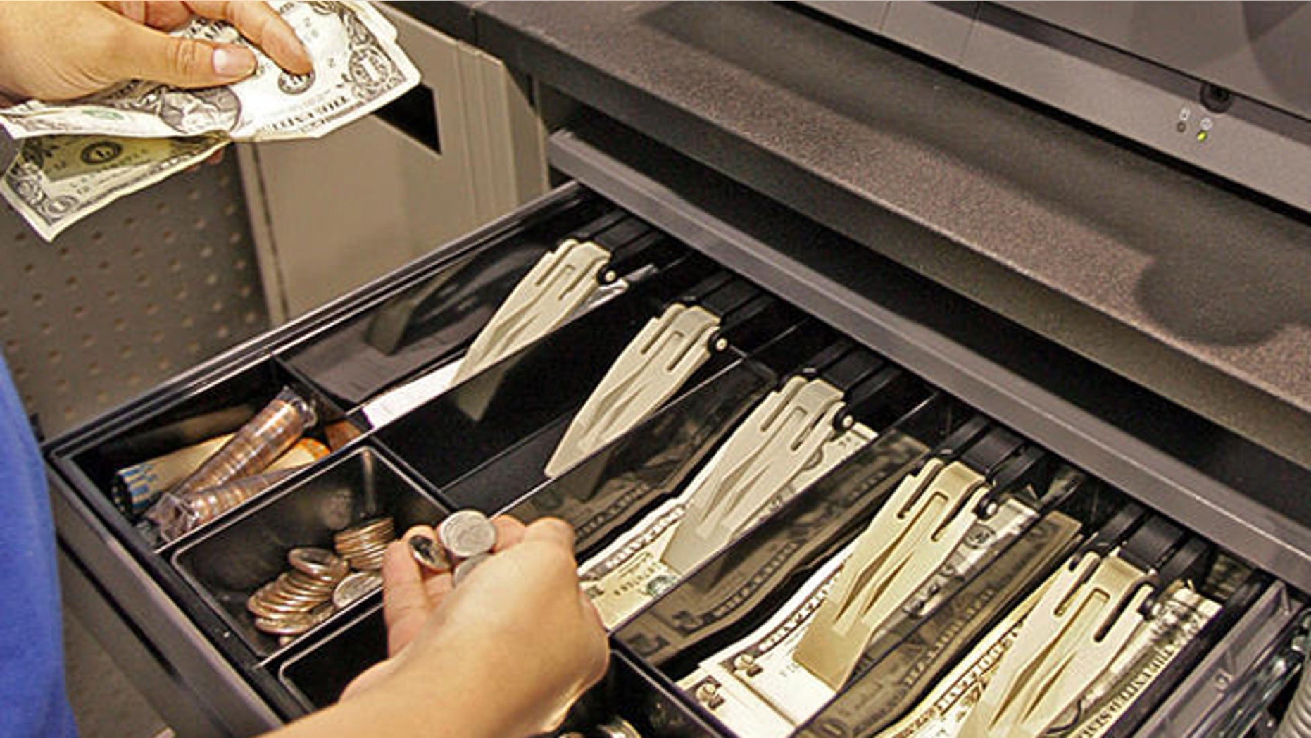 A Best Buy salesperson gives change at a Best Buy store in Mountain View, Calif., Tuesday, June 13, 2006. Inflation at the wholesale level slowed in May after two big months of increases, even though gasoline prices and inflation pressures outside of energy and food continued to climb. (AP Photo/Paul Sakuma)