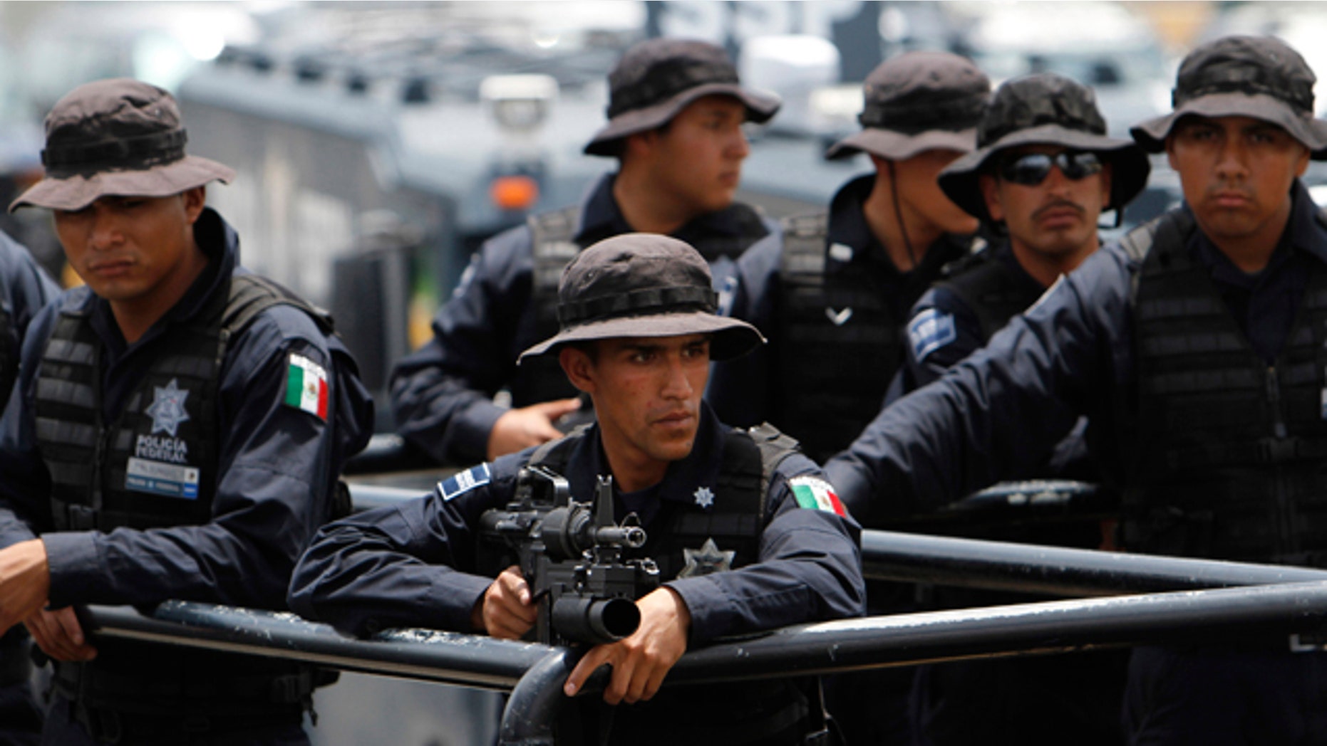 Aug. 27: Federal policemen form part of a caravan en route to Monterrey, at the federal police center in Mexico City.