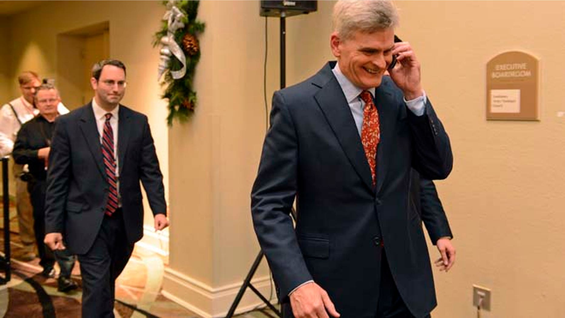 Dec. 6, 2014: Louisiana Senatorial Candidate, Bill Cassidy, right, takes a call while going to meet supporters at his election watch party in Baton Rouge, La. (AP)