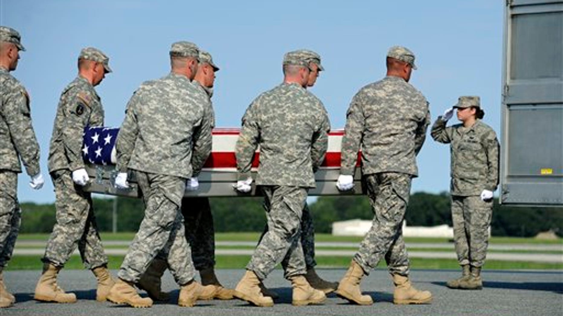 August 29: An Army carry team carries the transfer case containing the remains of Army Pfc. Jesse W. Dietrich, 20, of Venus, Texas, at Dover Air Force Base, DE.