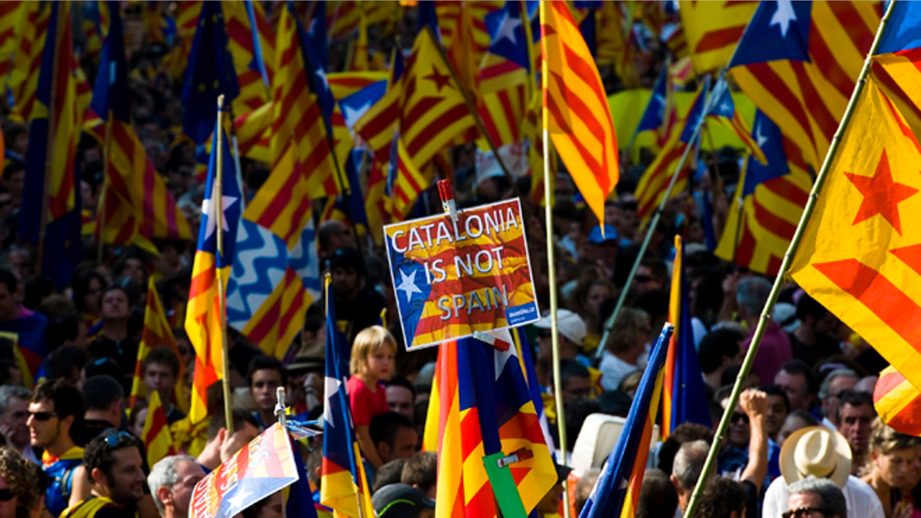 BARCELONA, SPAIN - SEPTEMBER 11: People hold Pro-independence Catalan flags in a demonstration calling for independence during the Catalonia's National Day on September 11, 2012 in Barcelona, Spain. Thousands of Catalans took to the streets of Barcelona demanding a split from Spain and control of their own economy under the slogan 'Catalonia: New European State' on Catalonia's National Day. The Diada Nacional is held every September 11 to remember the defeat of the Catalan troops in 1714. (Photo by David Ramos/Getty Images)