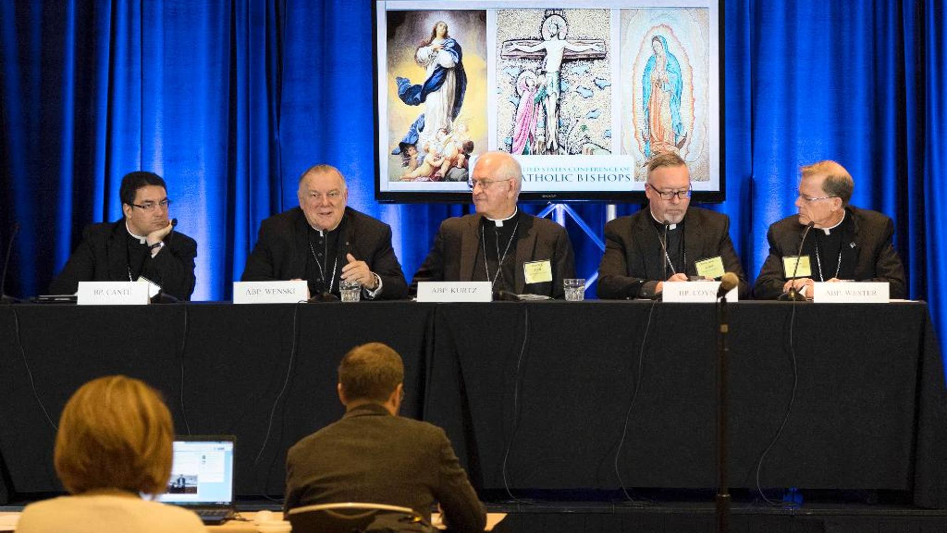 Bishop Oscar Cantú, left, of Las Cruses, Archbishop Thomas Wenski, of Miami, Archbishop Joseph Kurtz, of Louisville and president of the U.S. Conference of Catholic Bishops, Bishop Christopher Coyne, of Burlington and Archbishop John Wester, of Santa Fe, participate in a news conference during the U.S. Conference of Catholic Bishops' Spring General Assembly in St. Louis Wednesday, June 10, 2015. Roman Catholic bishops are condemning racism in the U.S. in light of national tensions over police treatment of African-Americans. (AP Photo/Sid Hastings)