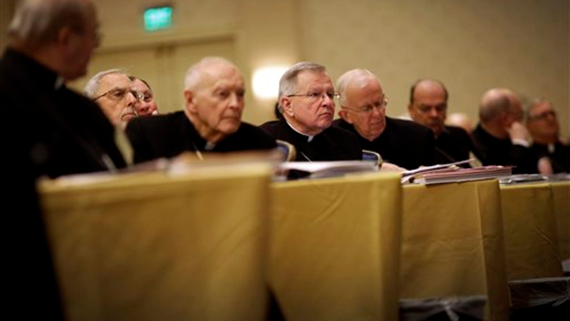 Archbishop Gregory Aymond of New Orleans, center, listens to a report as he sits with fellow bishops at the United States Conference of Catholic Bishops' annual fall meeting in Baltimore, Monday, Nov. 11, 2013, their first national meeting since Pope Francis was elected. (AP Photo/Patrick Semansky)