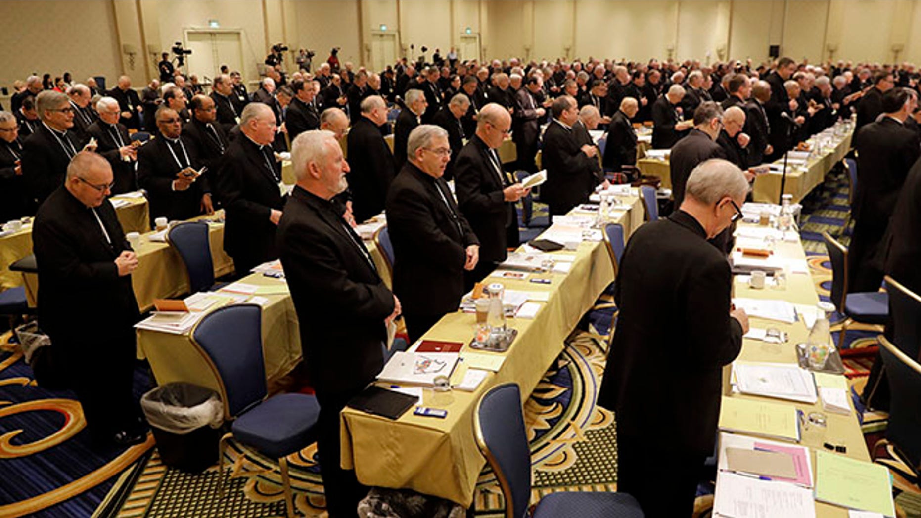 Members of the United States Conference of Catholic Bishops recite a group prayer during the USCCB's annual fall meeting in Baltimore, Tuesday, Nov. 15, 2016. Cardinal Daniel DiNardo of the Archdiocese of Galveston-Houston was elected Tuesday as president of the USCCB. (AP Photo/Patrick Semansky)