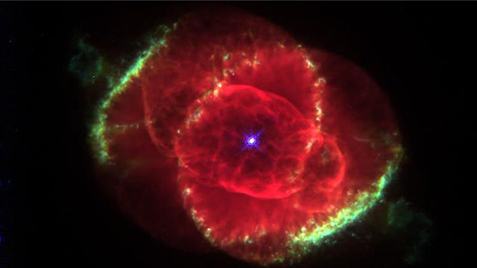 Three thousand light-years away, a dying star throws off shells of glowing gas in this image from the Hubble Space Telescope of the Cat's Eye Nebula.