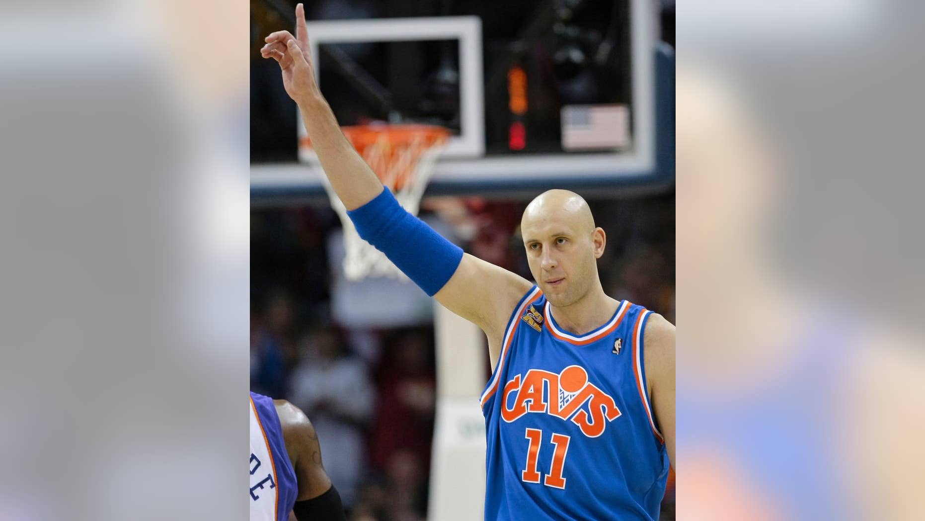 FILE - In this Dec. 2, 2009, file photo, Cleveland Cavaliers' Zydrunas Ilgauskas, of Lithuania, acknowledges the crowd while entering an NBA basketball game against the Phoenix Suns in Cleveland. Ilgauskas, a gentle giant who connected with Cleveland fans and became one of the city's most beloved athletes, will have his No. 11 jersey retired during halftime ceremonies Saturday, March 8, 2014, by the Cavaliers. (AP Photo/Tony Dejak, File)