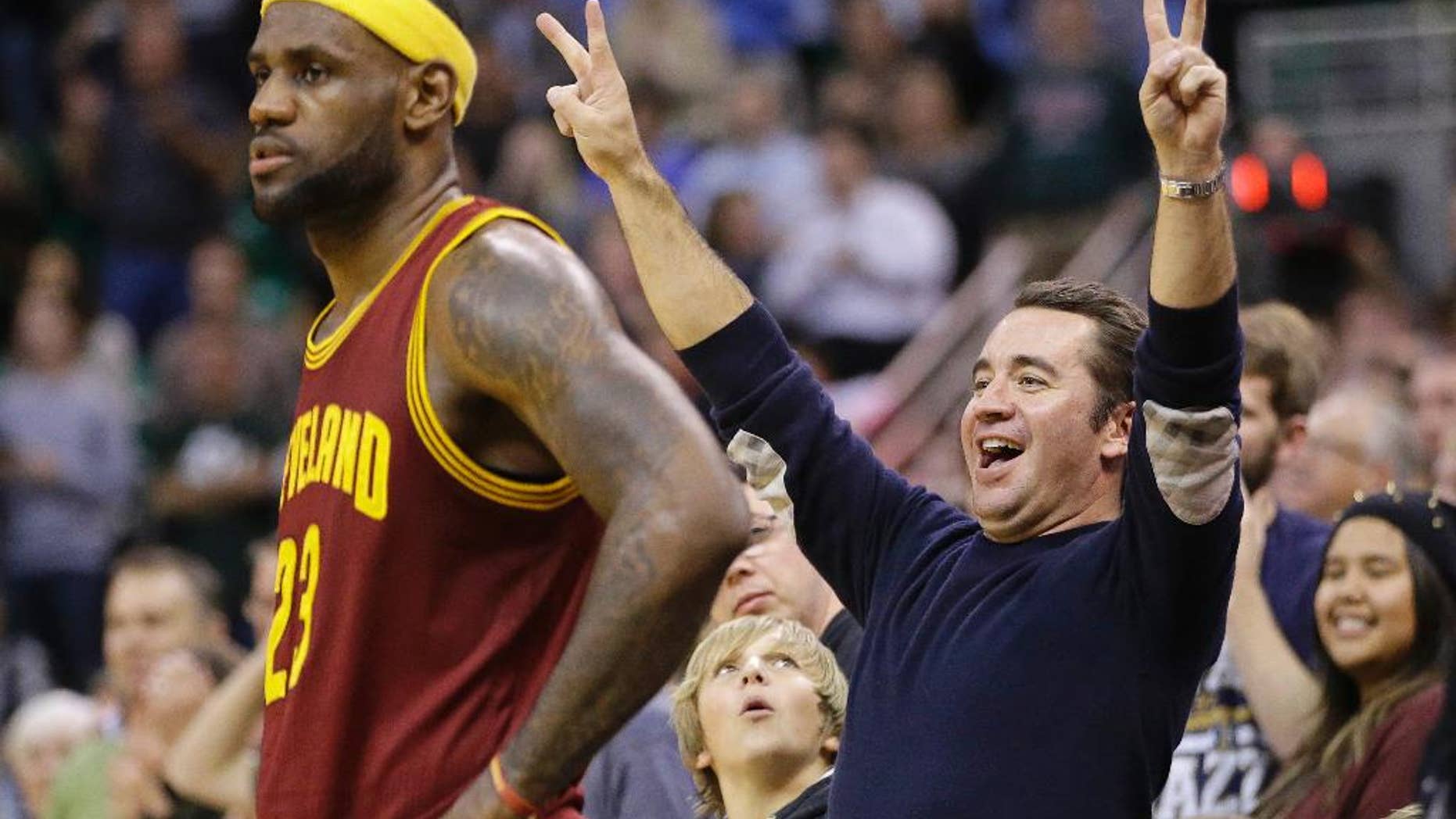 A Utah Jazz fan celebrates as Cleveland Cavaliers' LeBron James (23) waits during the second half of an NBA basketball game Wednesday, Nov. 5, 2014, in Salt Lake City. The Jazz won 102-100. (AP Photo/Rick Bowmer)
