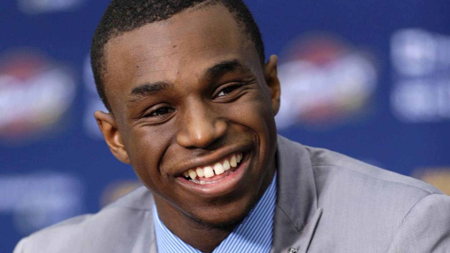 FILE - In this June 27, 2014, file photo, Andrew Wiggins, the Cleveland Cavaliers No. 1 draft pick, answers questions during an NBA basketball conference in Independence, Ohio. Wiggins will sign his rookie contract with the Cavaliers, an agreement that would prevent any potential trade involving the small forward from being completed for 30 days, a person familiar with the negotiations says. (AP Photo/Tony Dejak, File)