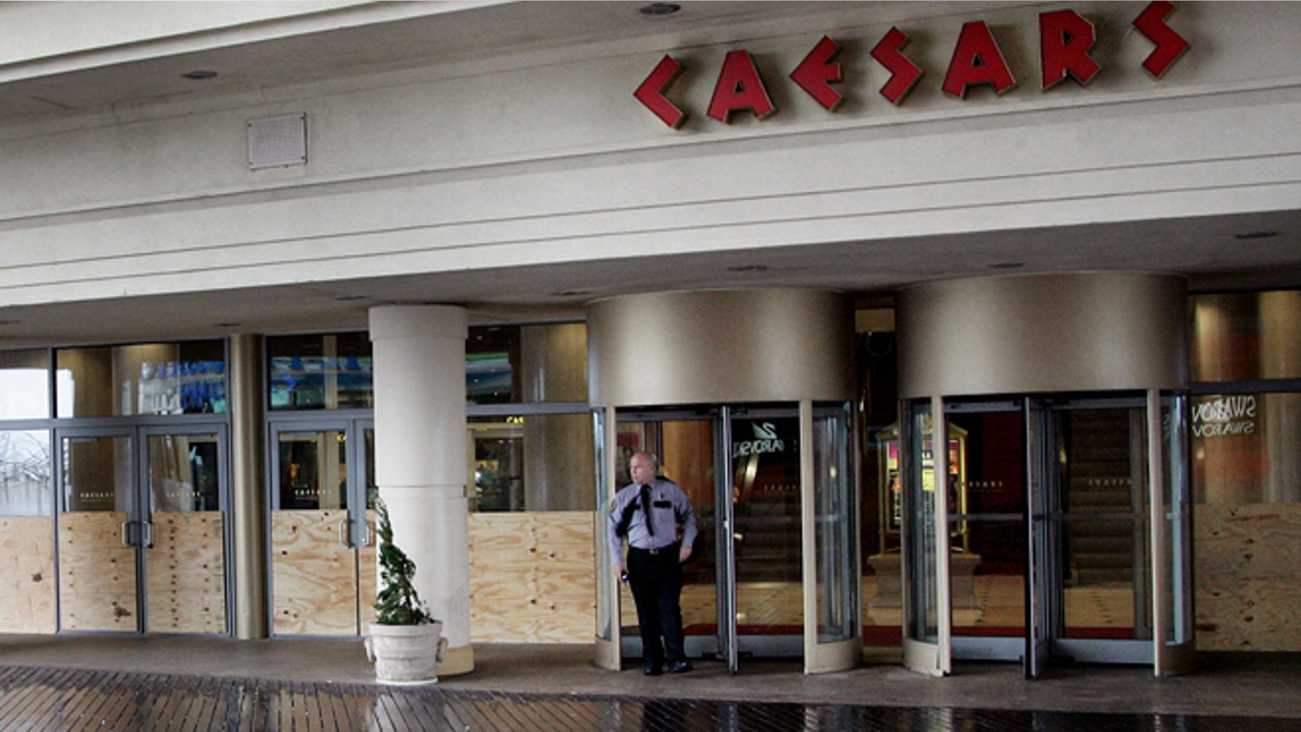 FILE: A security guard stands outside the entrance of Caesar's Casino on the Atlantic City boardwalk.