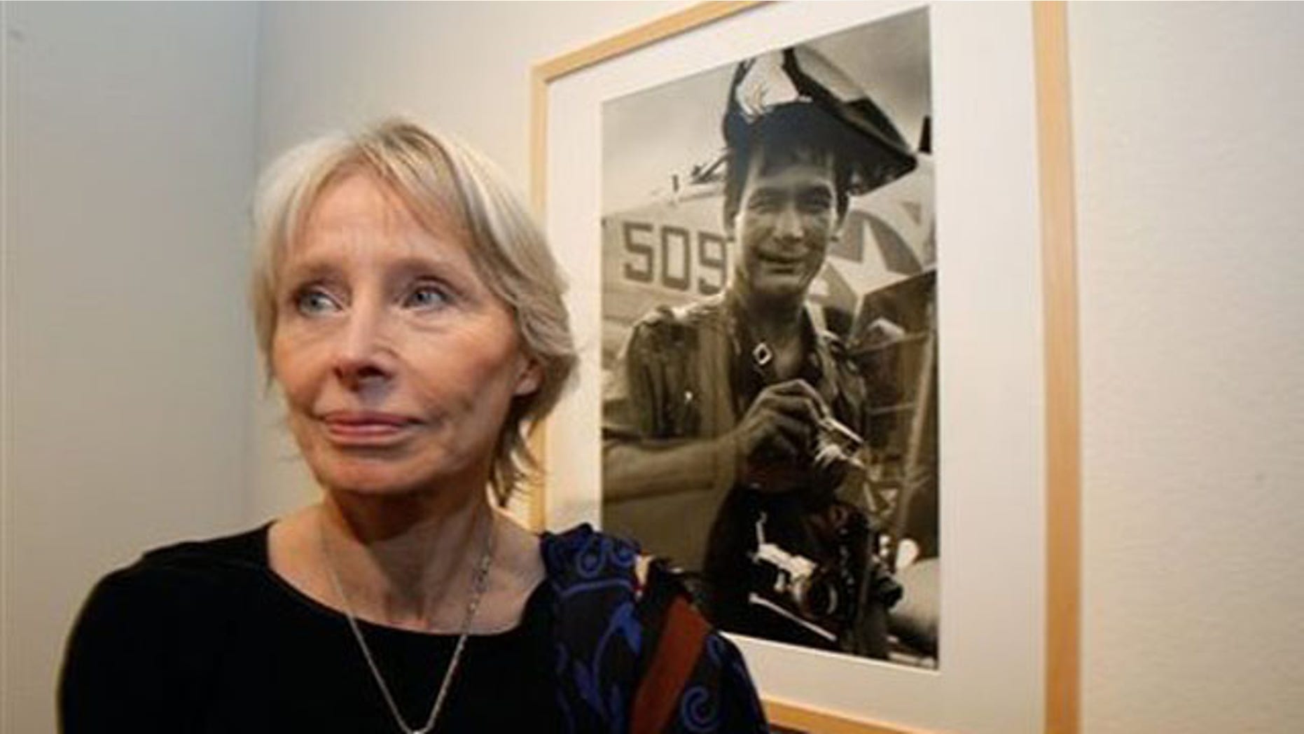 Feb. 8, 2011: Cecile Blumental, nee Schrouben, friend of Henri Huet, stands next to a photograph of Huet at the 'Henri Huet, Vietnam' exhibition at the Maison Europeenne de la Photographie, MEP, in Paris.
