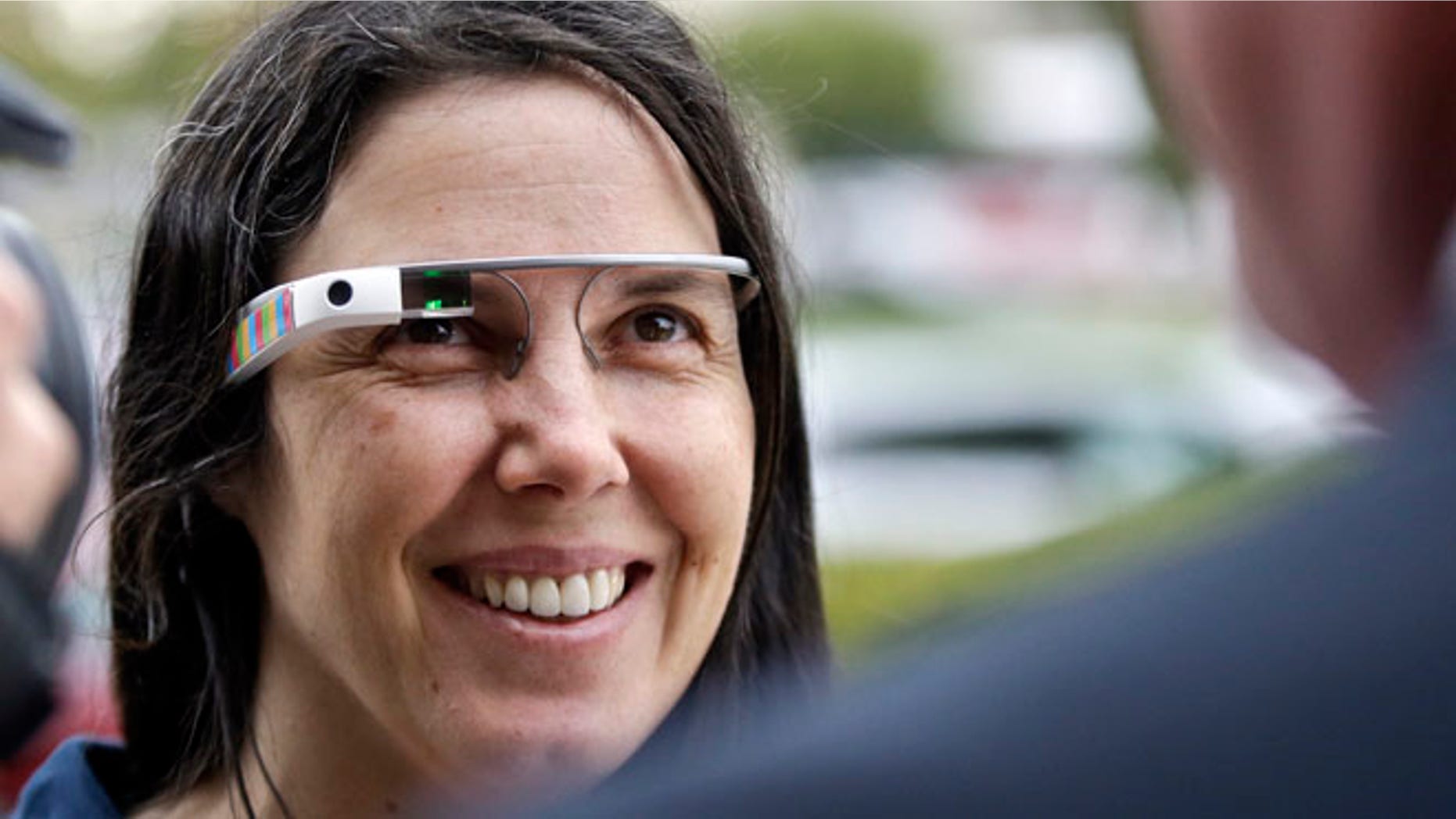 Cecilia Abadie wears her Google Glass as she talks with her attorney outside of traffic court in this Dec. 3, 2013 file photo taken in San Diego. The California woman believed to be the first cited for wearing Google's computer-in-an-eyeglass while driving says she was within her rights and violated no law. The case to be tried Thursday Jan. 16, 2014 in a San Diego traffic court could help shape future laws on wearable technology as it goes mainstream.