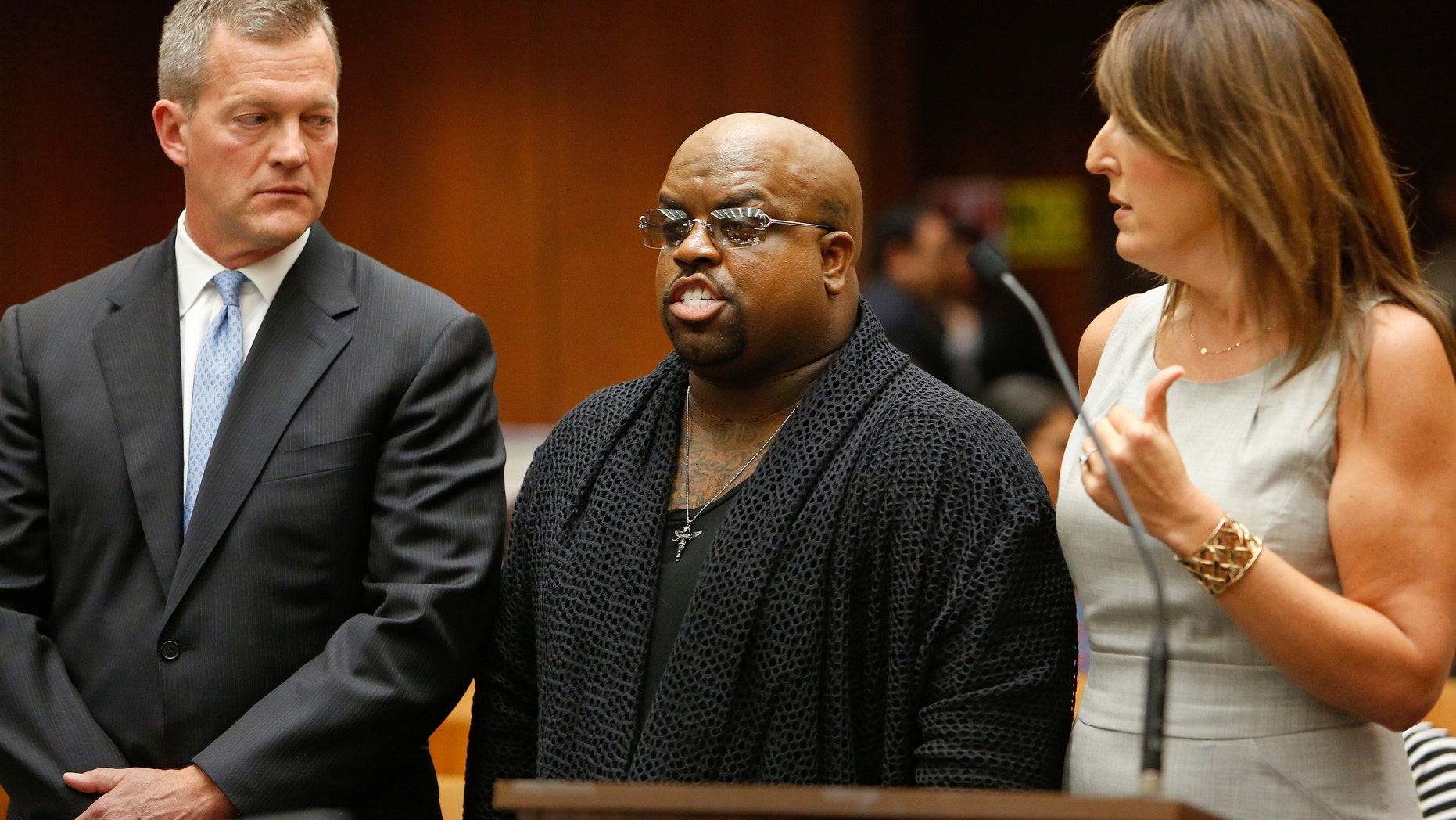 Grammy Award winning singer and "The Voice" TV judge CeeLo Green (C), stands with his attorneys after being charged with one count of furnishing a controlled substance. (REUTERS/Mel Melcon/The Los Angeles Times/Pool)