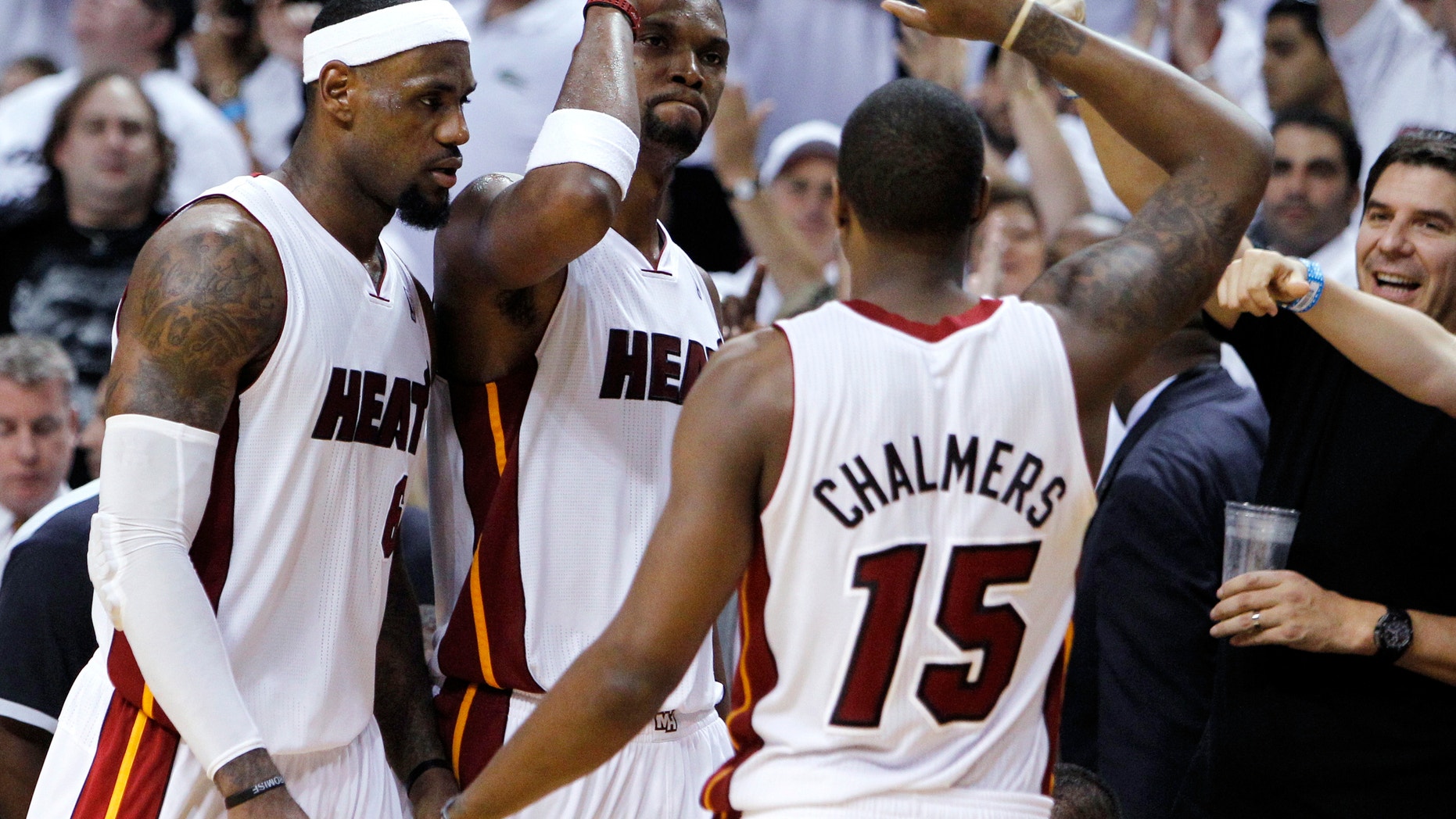 June 9, 2012: Miami Heat's Chris Bosh, center, Mario Chalmers, right, and LeBron James congratulate each other during the second half of Game 7 of the NBA basketball playoffs Eastern Conference finals.