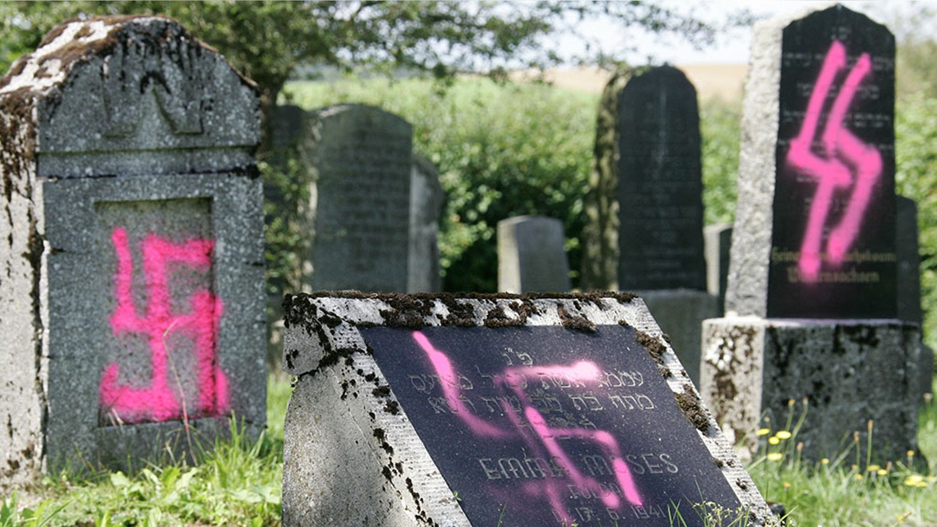Graves desecrated by vandals with Nazi swastikas and anti-semitic slogans are pictured in the Jewish cemetery of Weyhers, near the city of Ebersburg, Germany