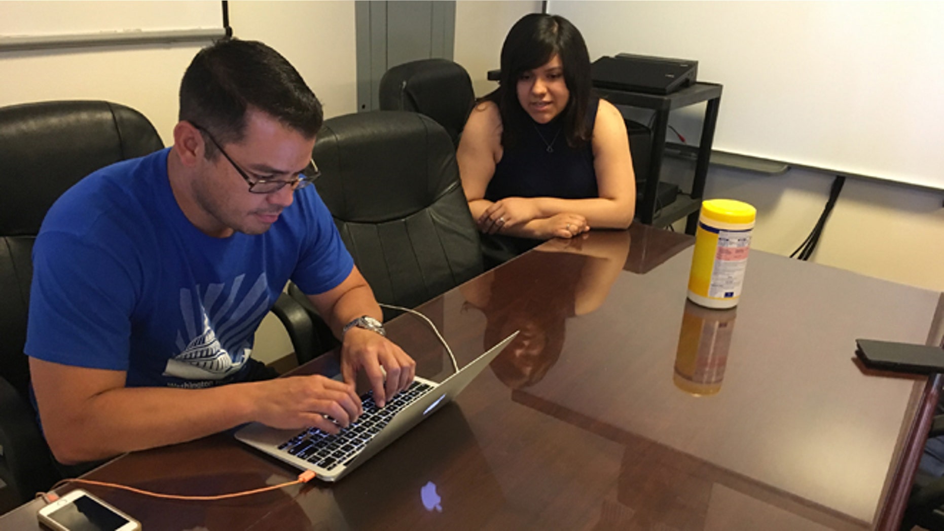 In this Wednesday, June 22, 2016 photo, Jesus Villarreal and Martha Guzman of the LULAC National Educational Service Centers, Inc., work on Hispanic student-related programs in the Albuquerque office, N.M. The nation's Hispanic population grew by 2.2 percent to 56.6 million, and New Mexico had the largest percentage of Latinos in the country at 48 percent, according to new information from the U.S. Census Bureau. (AP Photo/Russell Contreras)