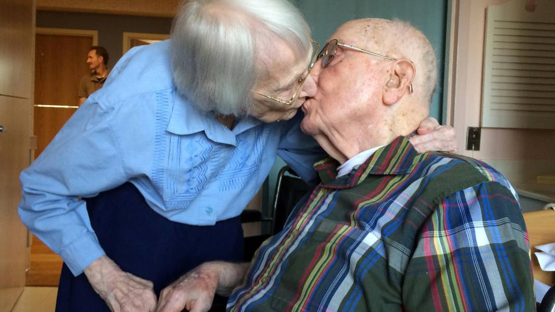Walter and Leslie Kimmel, who are both 100 years old, enjoy a kiss as they celebrate their 75th wedding anniversary Tuesday, Aug. 18, 2015, at Charlestown Retirement Community in Catonsville, Md. The Kimmels met at Emmanuel Lutheran Church in Baltimore when they were 22 years old. Leslie played the organ and Walter sang in the choir. (Paul J. Kessler/WBFF-TV via AP)