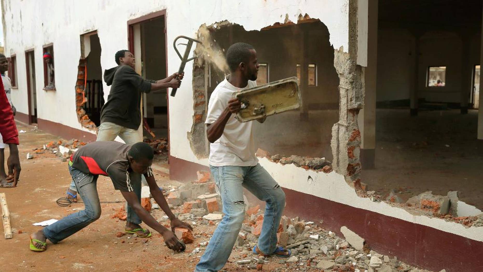 FILE - In this Tuesday, Dec. 10, 2013 file photo, a Christian mob attacks a mosque in Bangui, Central African Republic. Ten mosques have reopened in Central African Republic's capital, Bangui, as Muslims begin to trickle back home after months of sectarian violence. (AP Photo/Jerome Delay, File)