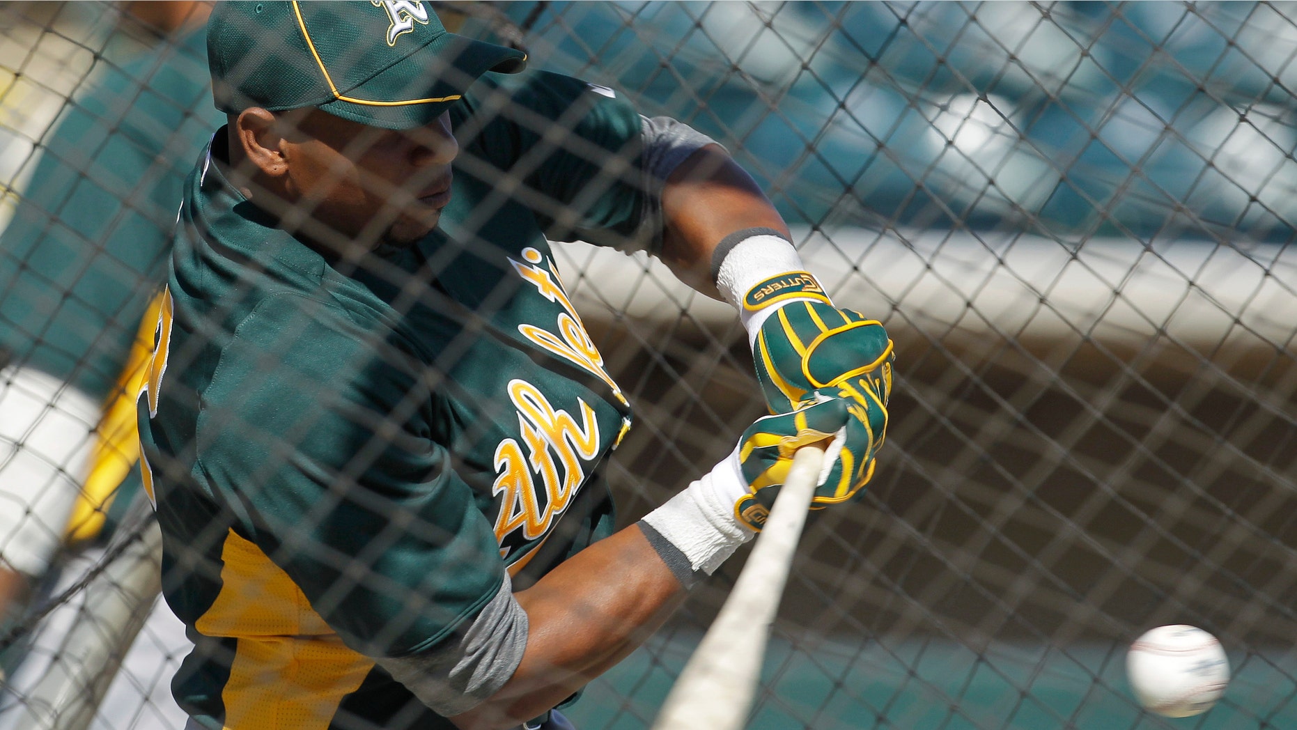 Oakland Athletics' Yoenis Cespedes hits during a baseball spring training workout Sunday, March 4, 2012, in Phoenix. (AP Photo/Darron Cummings)