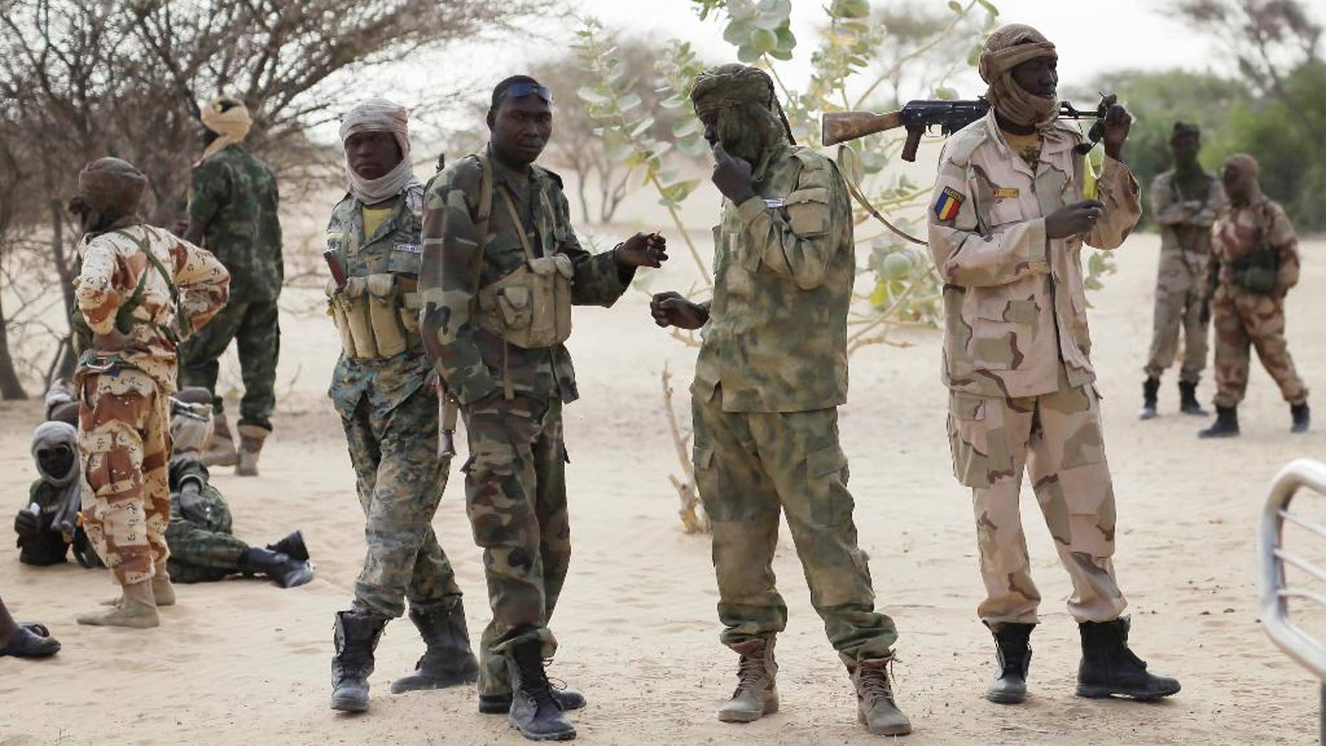 Chadian troops previously stationed by the Sudanese border make a stop on their way to lake Chad near Baga Sola Friday March 6, 2015. Large contingents of Chadian troops were seen heading to the region bordering Nigeria, where residents and an intelligence officer said Boko Haram fighters are massing at their headquarters in the northeast Nigerian town of Gwoza in preparation for a showdown with multinational forces. (AP Photo / Jerome Delay)