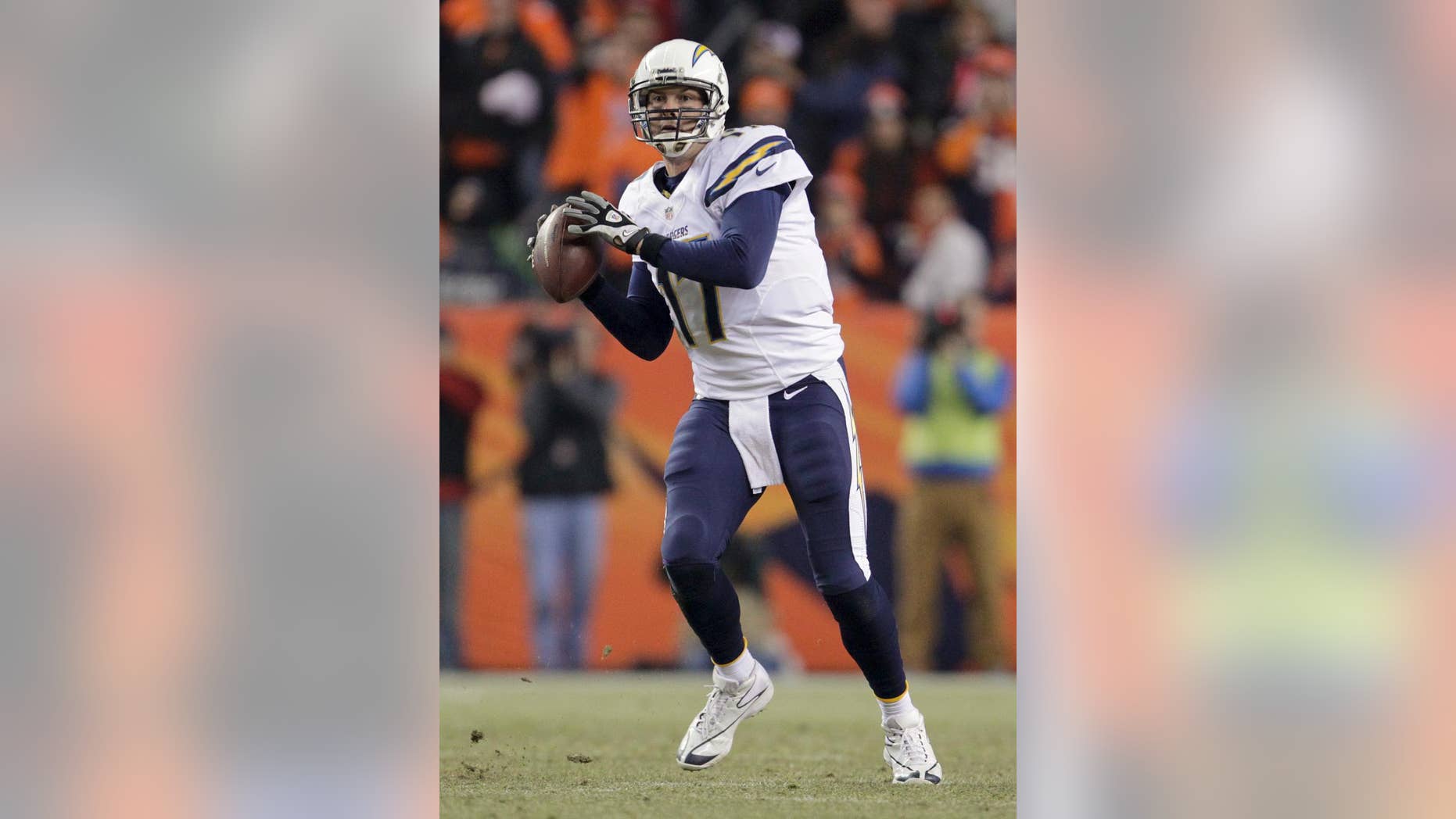 FILE - In this Dec. 12, 2013, file photo, San Diego Chargers quarterback Philip Rivers looking to pass against the Denver Broncos in the second quarter of an NFL football game, in Denver. Rivers is a devout Catholic, so maybe he should send a thank-you card to the Vatican for the Chargers' good fortunes in December. The Chargers needed a lot to go right, and it did, from winning their final four games to having Miami and Baltimore both lose their final two games. (AP Photo/Joe Mahoney, File)