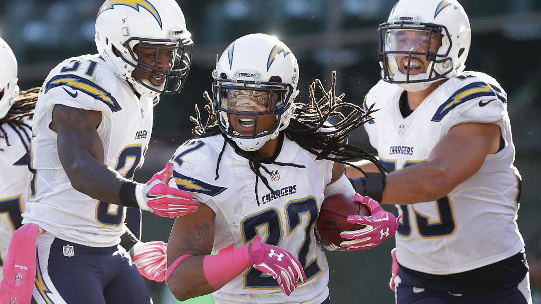 San Diego Chargers cornerback Jason Verrett (22) celebrates with cornerback Richard Marshall, left, and inside linebacker Andrew Gachkar (59) after intercepting Oakland Raiders quarterback Derek Carr during the fourth quarter of an NFL football game in Oakland, Calif., Sunday, Oct. 12, 2014. The Chargers won 31-28. (AP Photo/Ben Margot)