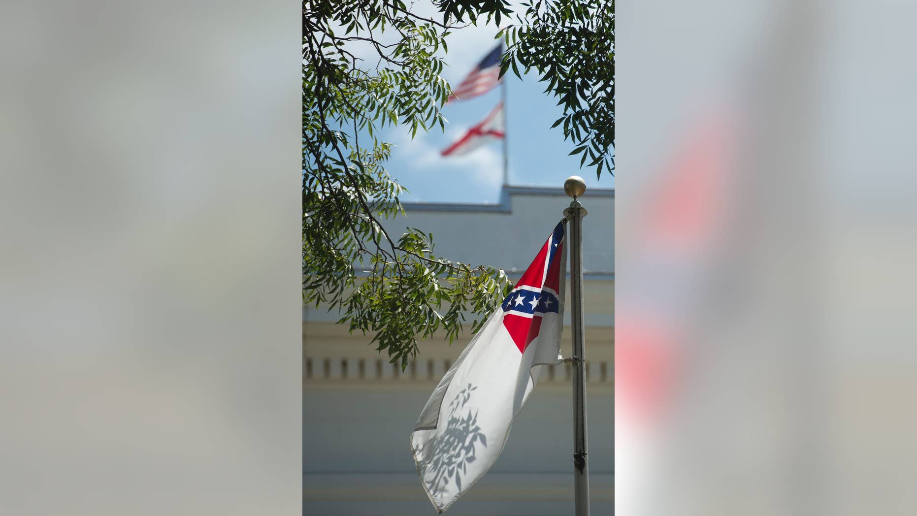 A confederate flag flies next to the Alabama Confederate Memorial on the grounds of the Alabama Capitol building in Montgomery, Ala., Monday, June 22, 2015. (Albert Cesare/The Montgomery Advertiser via AP) NO SALES; MANDATORY CREDIT