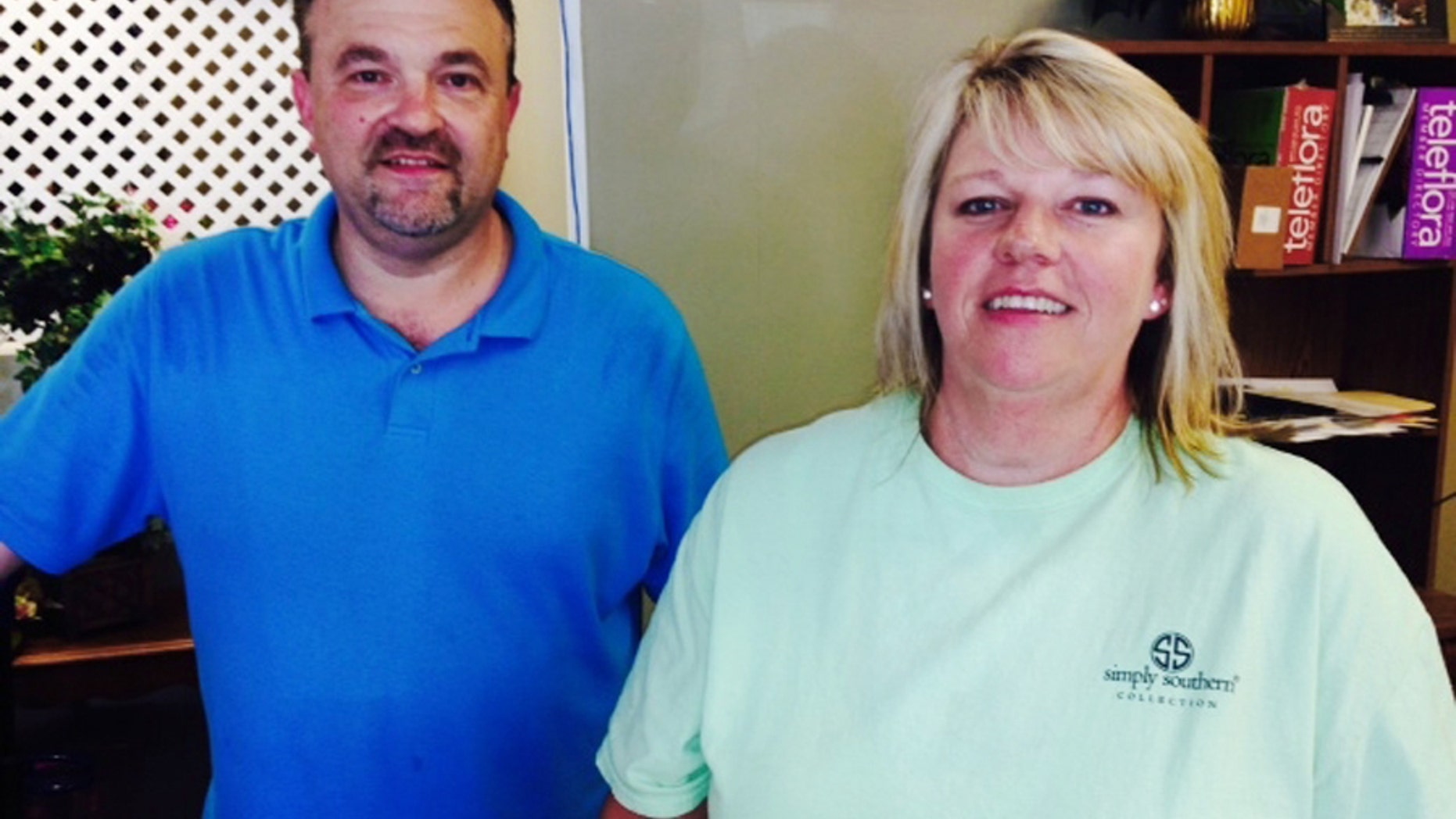 Todd Frady, left, and Debbie Dills of Frady's Florist in Kings Mountain, N.C., pose for a photo Thursday, June 18, 2015, after Dills called in the tip that ultimately led to the arrest of Dylann Storm Roof, the white man who police say killed people at a prayer meeting Wednesday at a black church in Charleston, S.C. Dills says she called Frady when she saw Roof driving, and Frady called a police officer he knew. (AP Photo/Steve Reed)