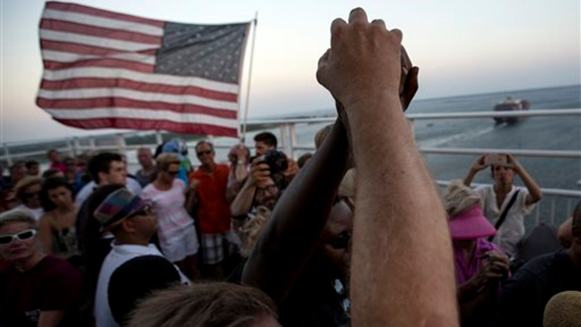 June 21: People raise their hands as a show of unity as thousands of marchers meet in the middle of Charleston's main bridge after nine black church parishioners were gunned down during a Bible study.
