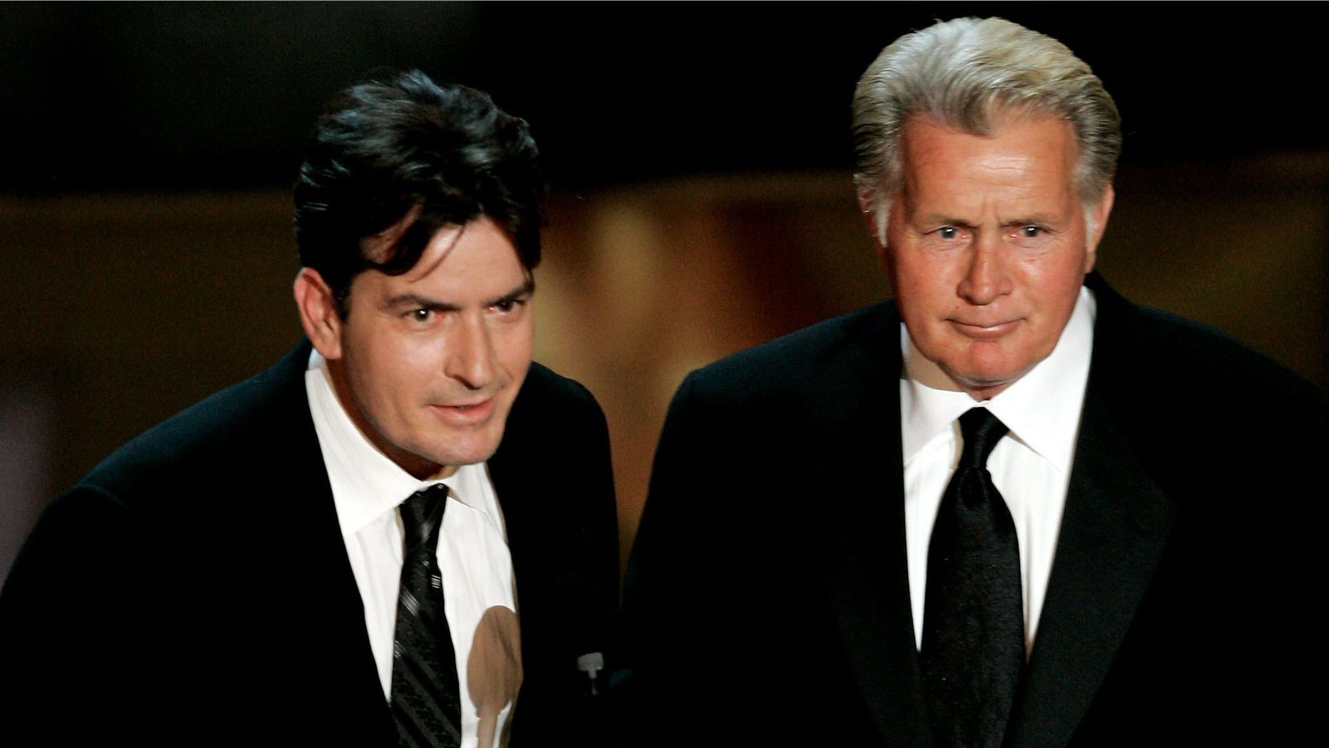 LOS ANGELES, CA - AUGUST 27: Actors Charlie Sheen (L) and Martin Sheen present the award for Outstanding Supporting Actress in a Drama Series onstage at the 58th Annual Primetime Emmy Awards at the Shrine Auditorium on August 27, 2006 in Los Angeles, California. (Photo by Vince Bucci/Getty Images)