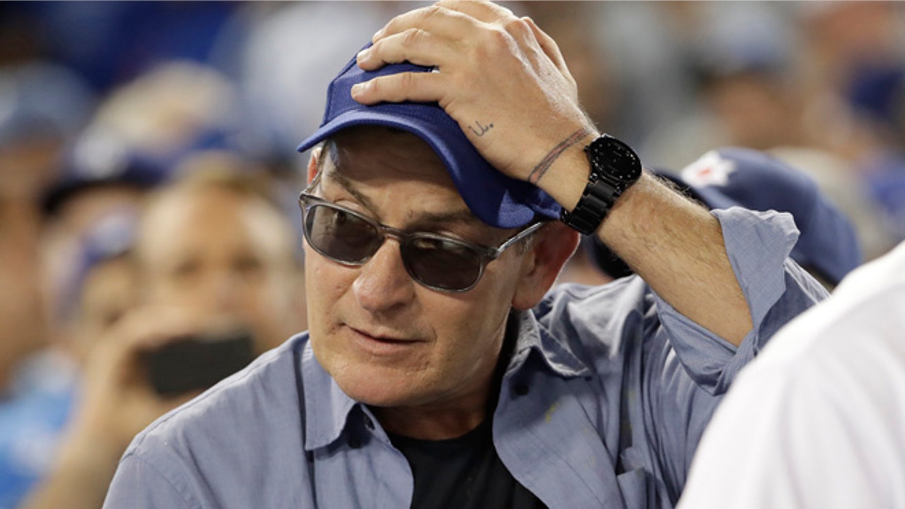 Actor Charlie Sheen reacts during the fifth inning of Game 4 of the National League baseball championship series between the Chicago Cubs and the Los Angeles Dodgers Wednesday, Oct. 19, 2016, in Los Angeles. (AP Photo/David J. Phillip)