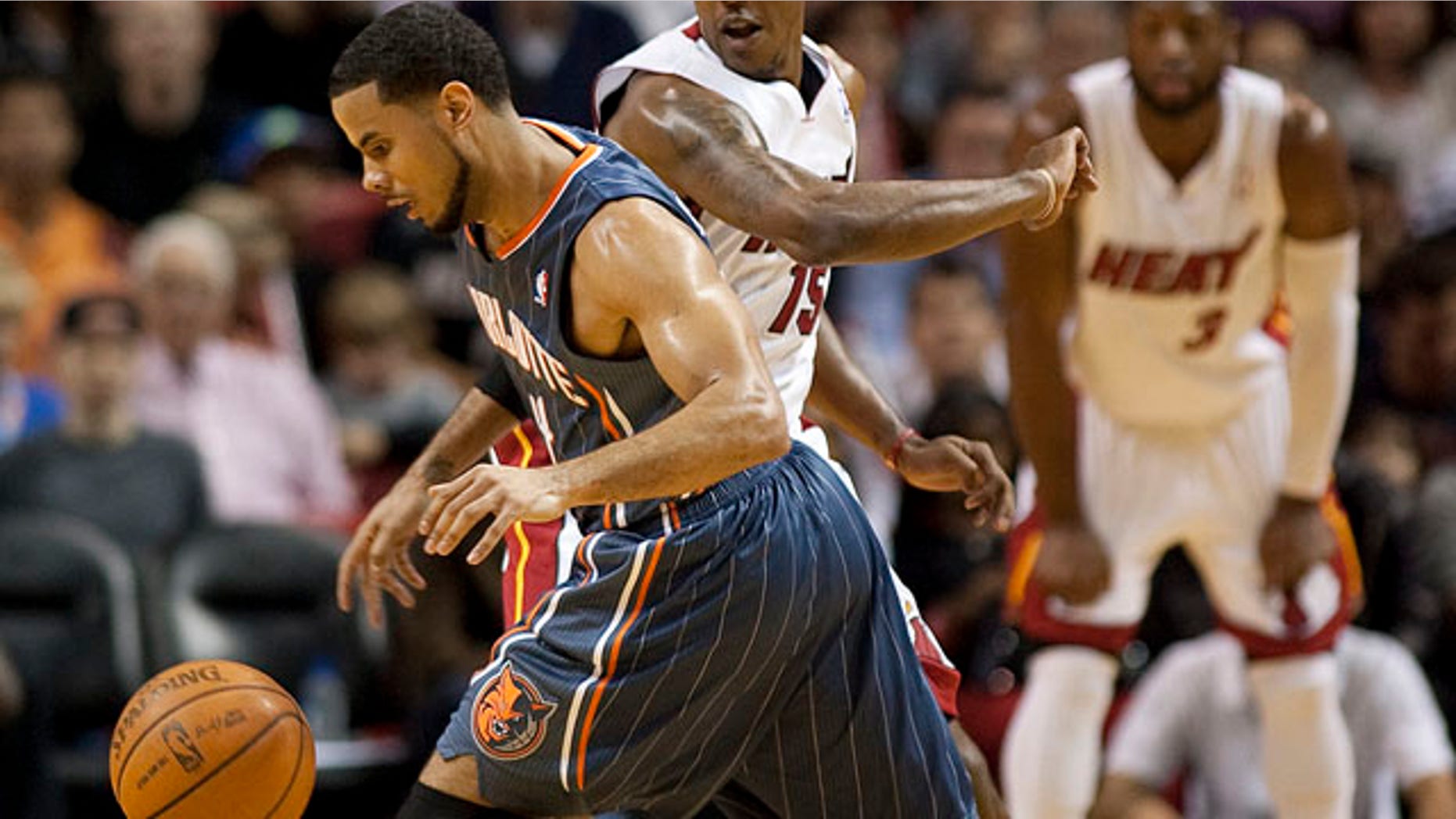Miami Heat guard Mario Chalmers defends as Charlotte Bobcats' forward Derrick Brown dribbles in the first half of their NBA basketball game in Miami, Florida January 1, 2012. REUTERS/Andrew Innerarity (UNITED STATES - Tags: SPORT BASKETBALL)