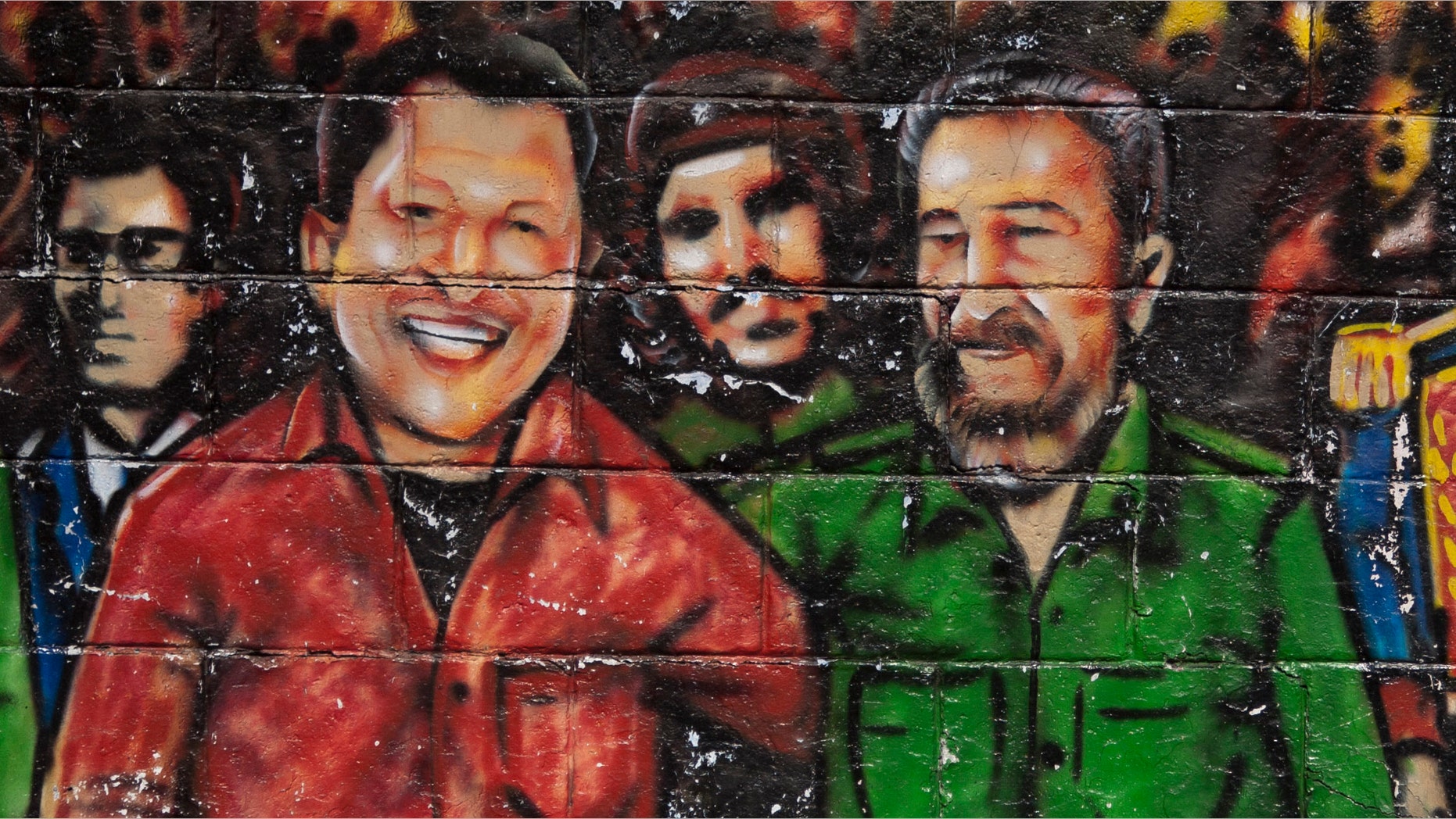 In this Feb. 22, 2012 file photo, a mural featuring Venezuela's President Hugo Chavez, left, and Cuba's Fidel Castro, adorns a wall in Caracas, Venezuela. (AP Photo/Ariana Cubillos, File)