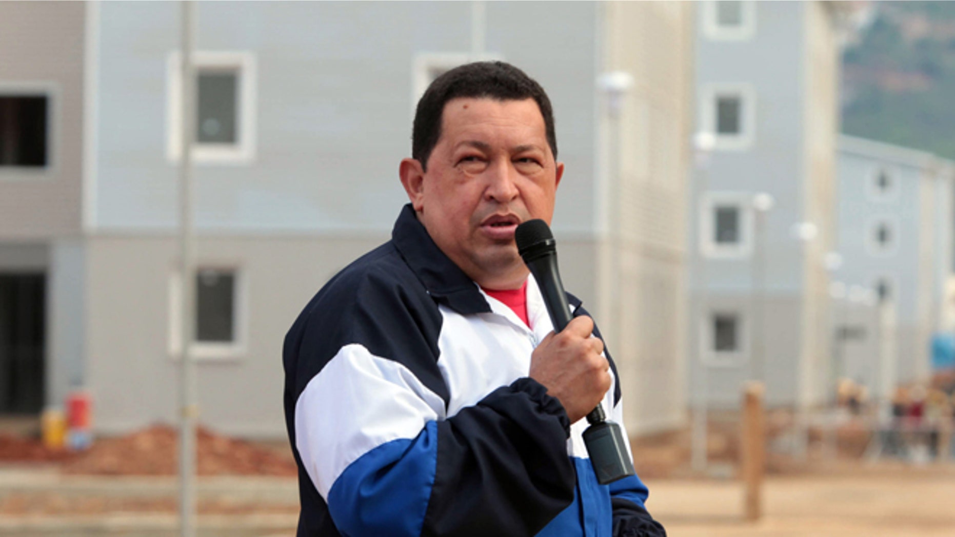 In this photo released by Miraflores Press Office, Venezuela's President Hugo Chavez speaks during a visit to a housing complex at Catia la Mar, Venezuela, Thursday, Aug. 9, 2012. Chavez says Venezuelan security forces have arrested a U.S. citizen and suspect he is a mercenary who could be involved in an alleged plot to destabilize the country if the opposition's candidate loses the upcoming presidential election. (AP Photo/Miraflores Press Office)